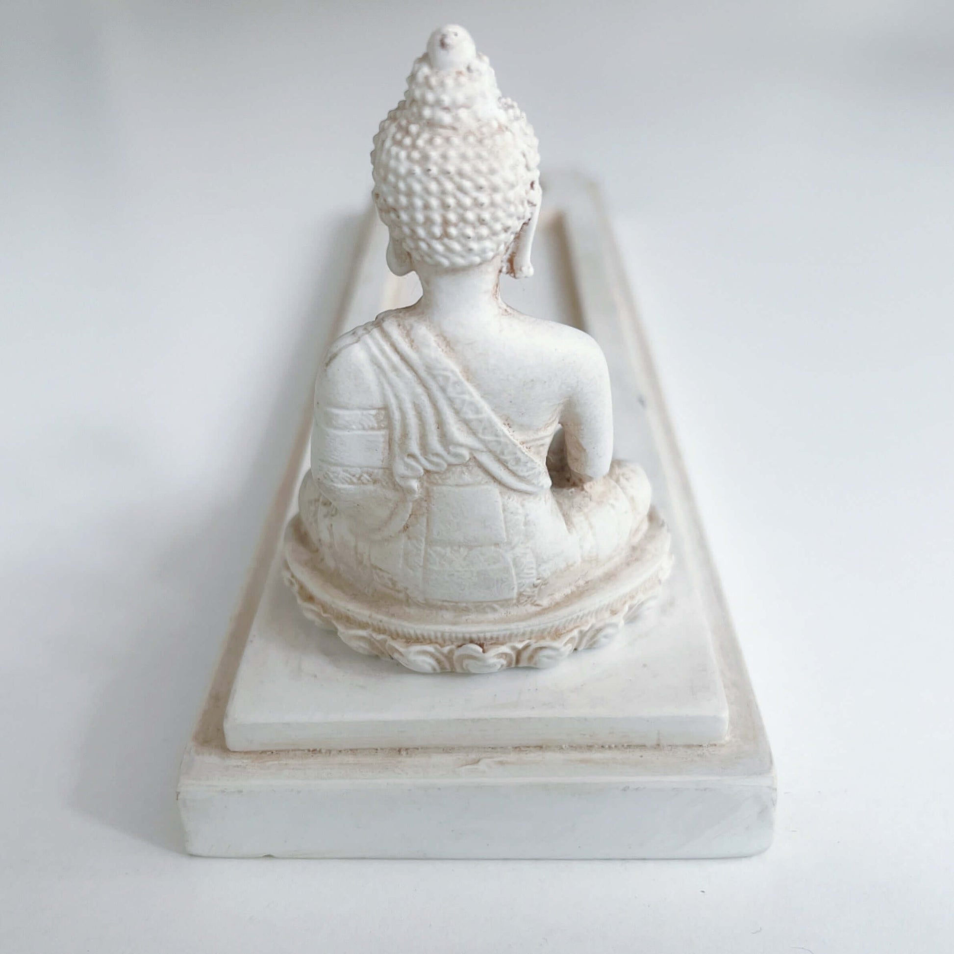 Back view of incense holder, showing the Buddha from behind.