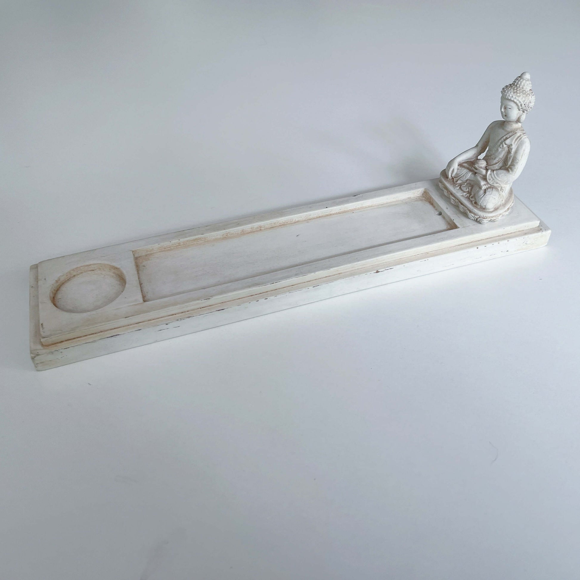Side view of incense holder, the Buddha sits at one end of long rectangle, the remaining part is to catch the ash.