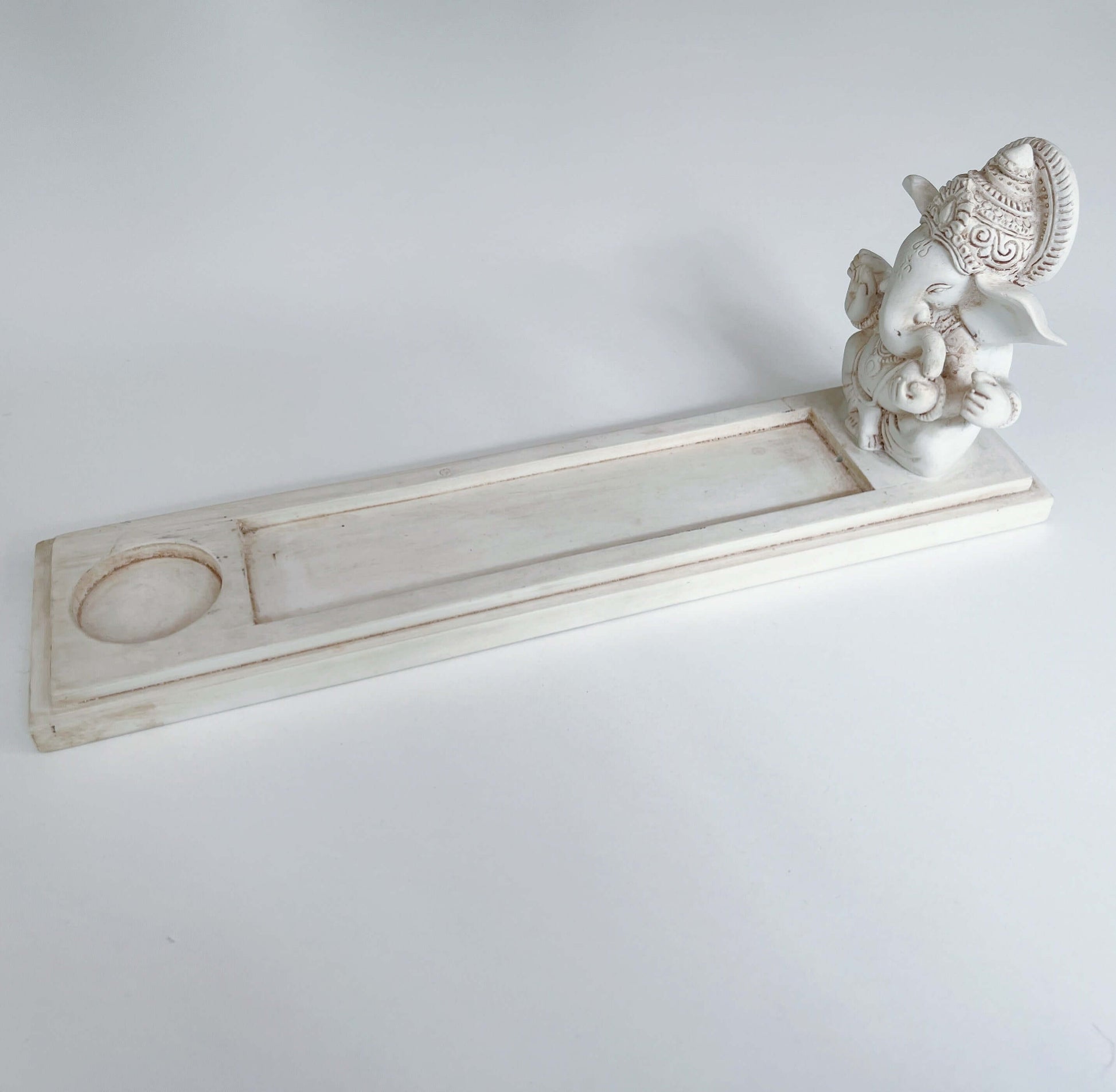 Side view of incense holder, Ganesha sits at one end of long rectangle, the remaining part is to catch the ash.