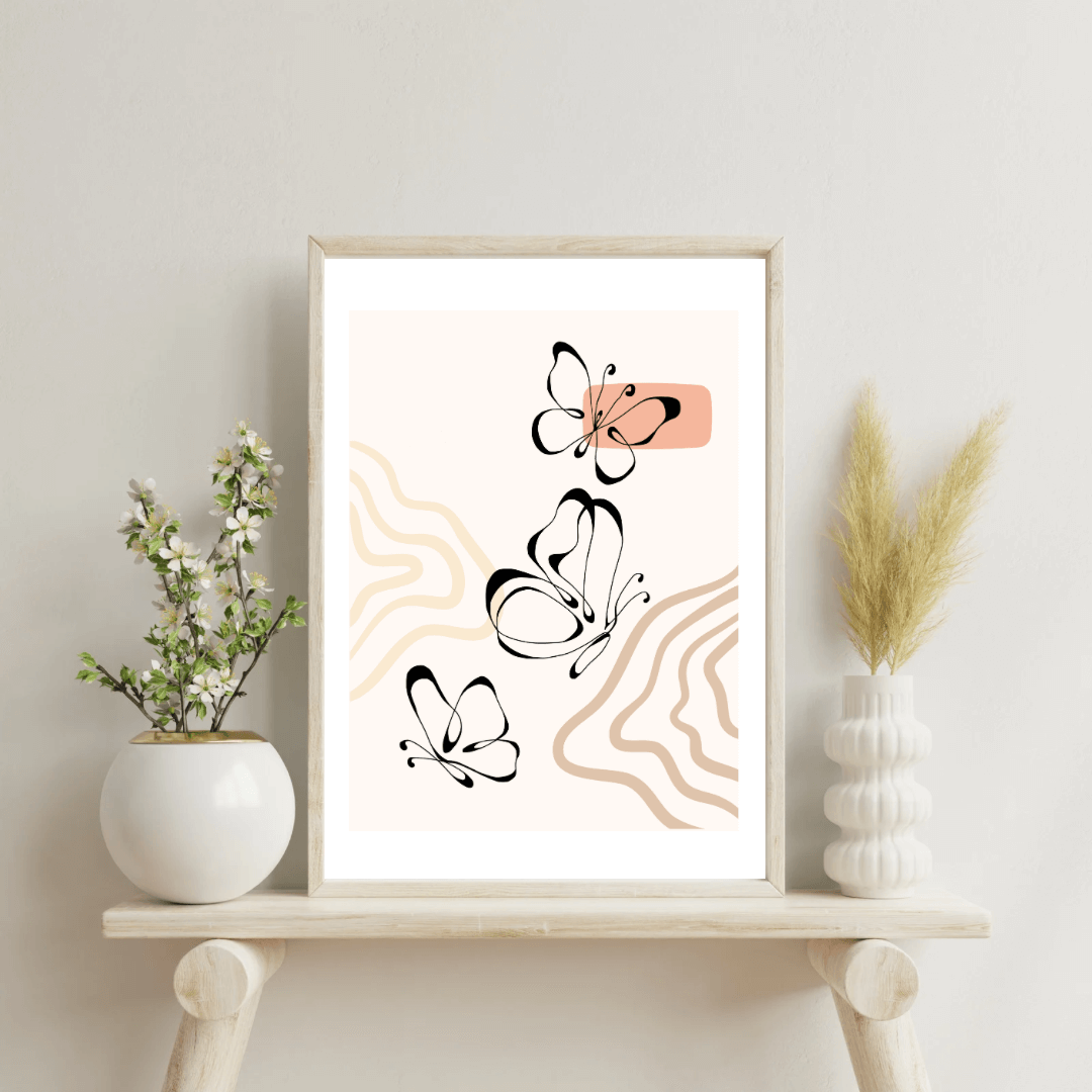 Three black line art butterflies on wave pattern boho background in peaches and beige in white frame on white wall.