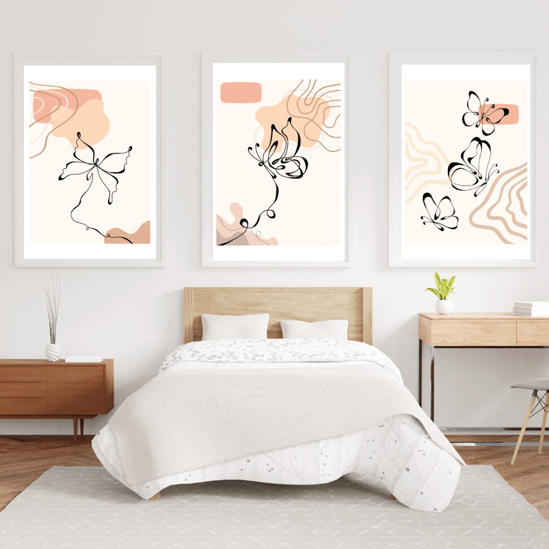 Boho and minimalist butterfly print set of three on bedroom wall.