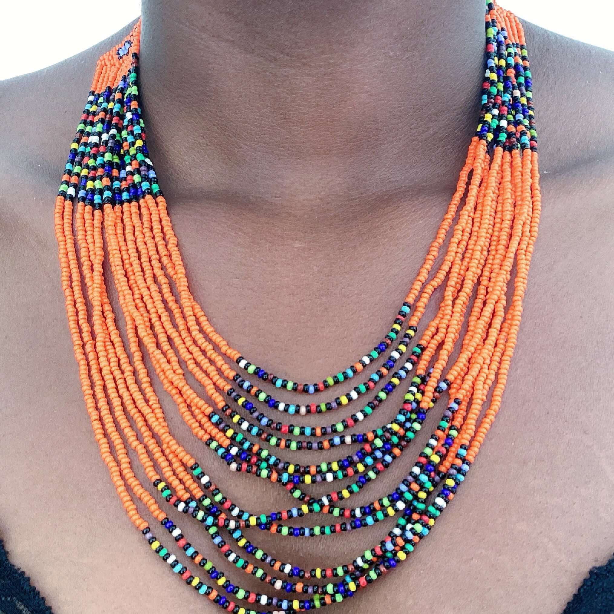 Detail view of thirteen strand zulu beaded necklace in bands of orange and multi mix colors alternating.
