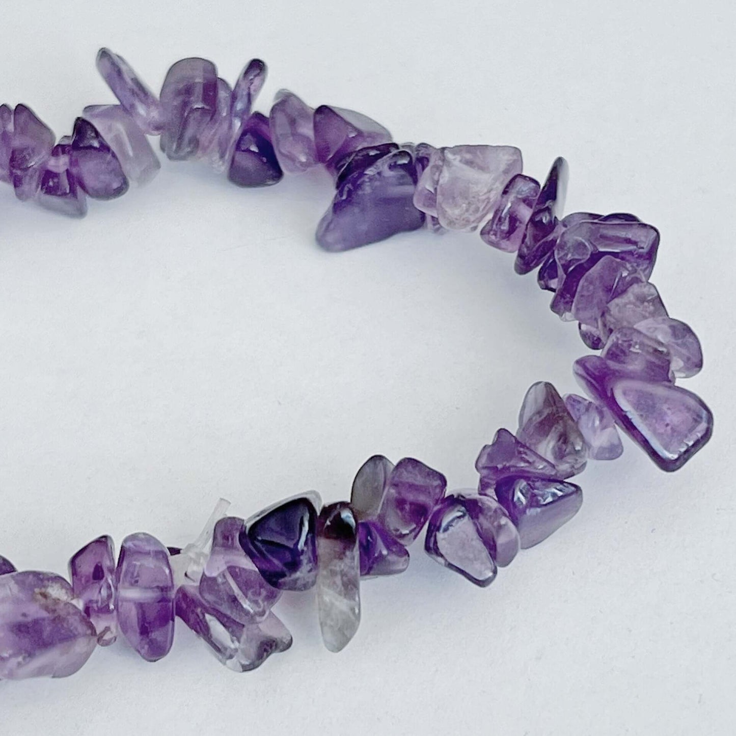 Detail view of the tumbled semi-precious stones, shades of purple.