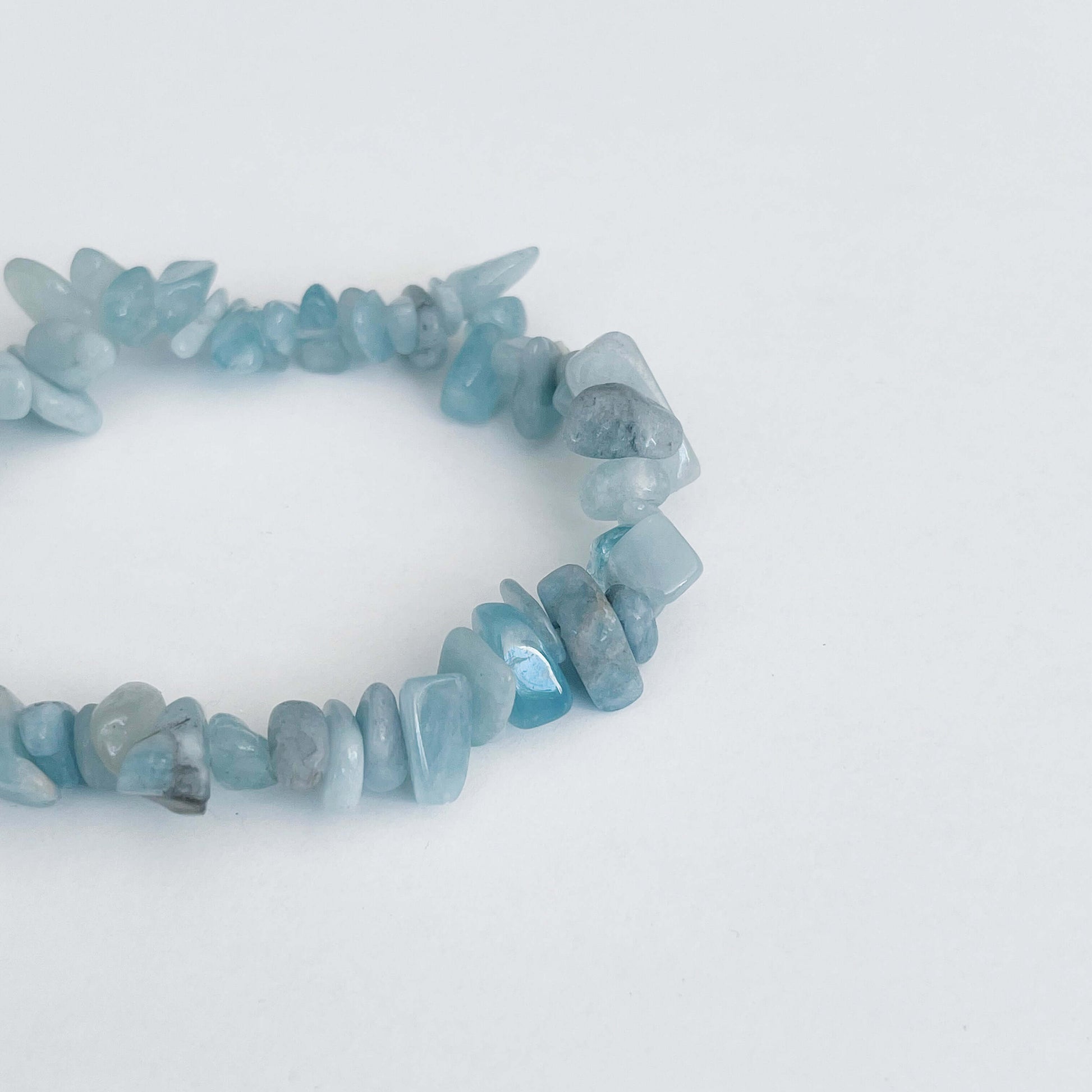 Detail view of the tumbled semi-precious stones, shades of aquamarine.