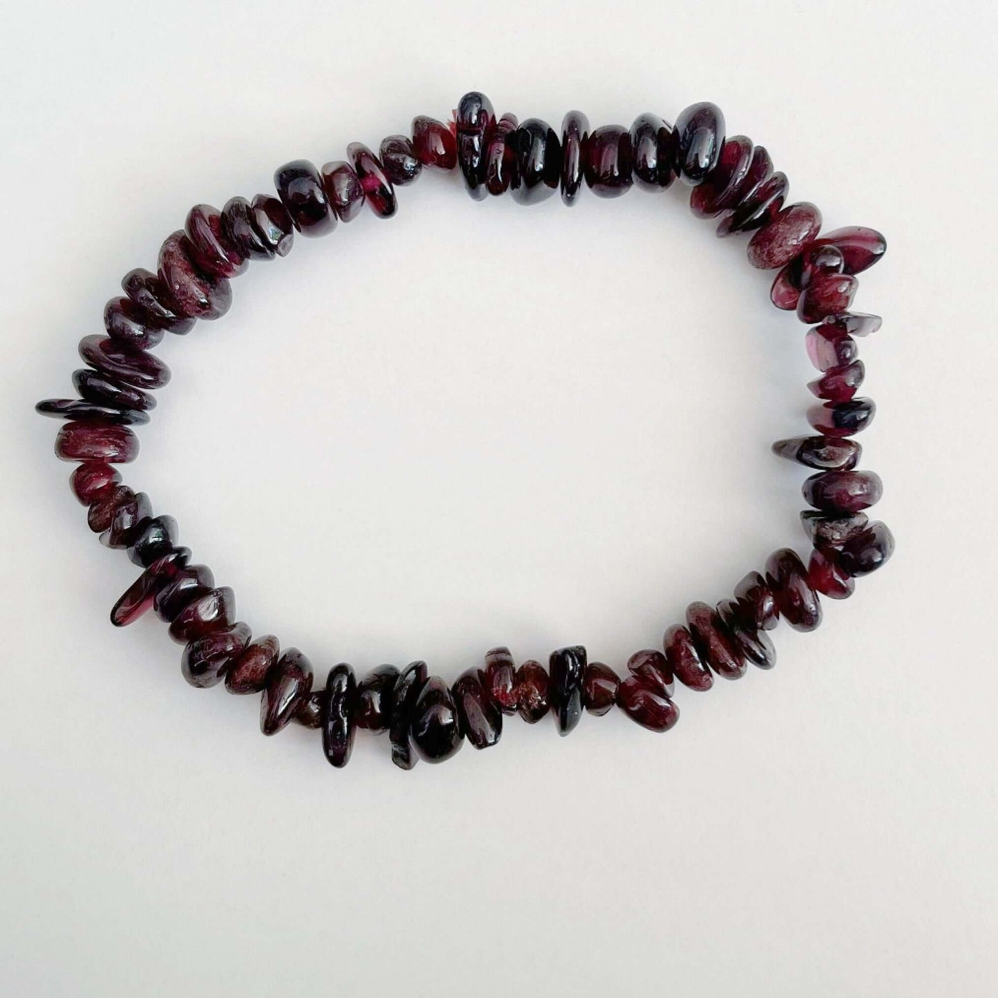 Top view of the tumbled semi-precious stones, shades of deep plum/ruby translucent.