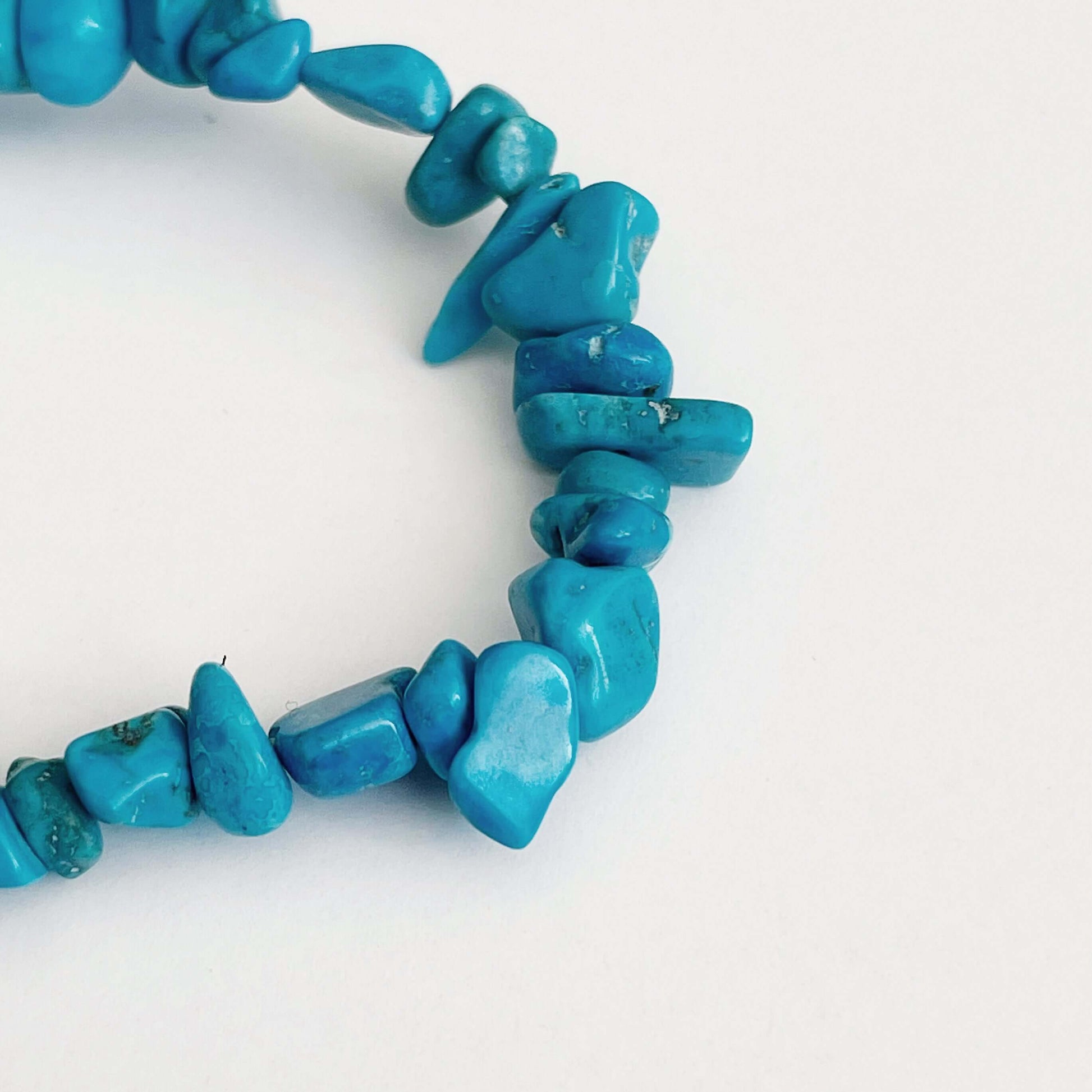 Detail view of the tumbled semi-precious stones, shades of turquoise.