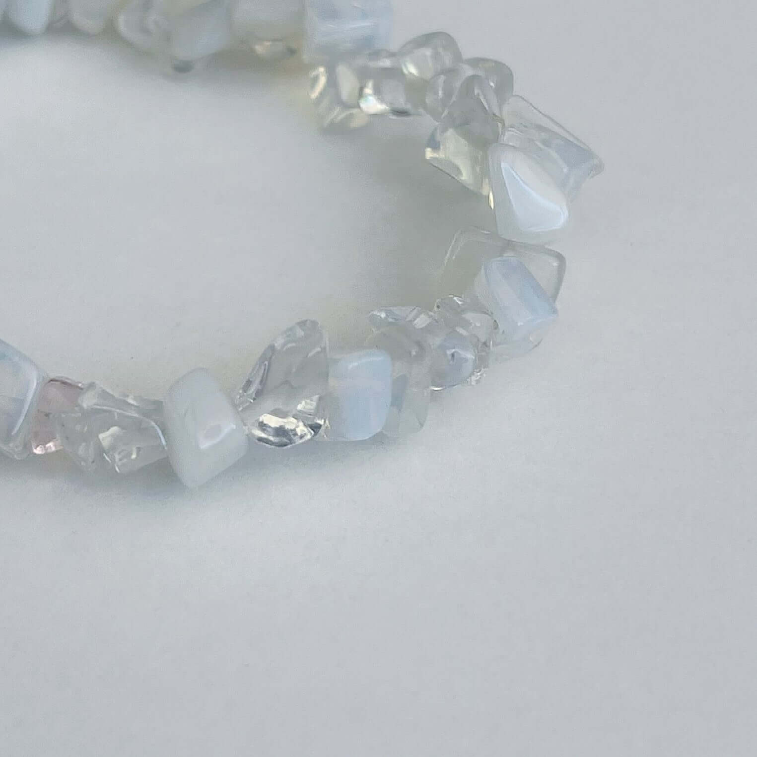 Detail view of the tumbled semi-precious stones, shades of clear and white.