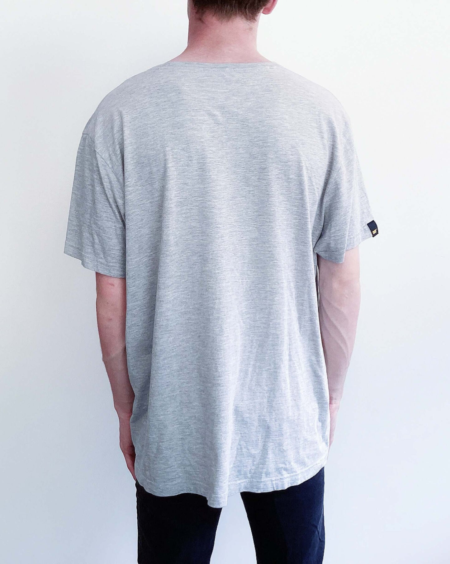 back view of light grey, drop shoulder tshirt, blank at the back.