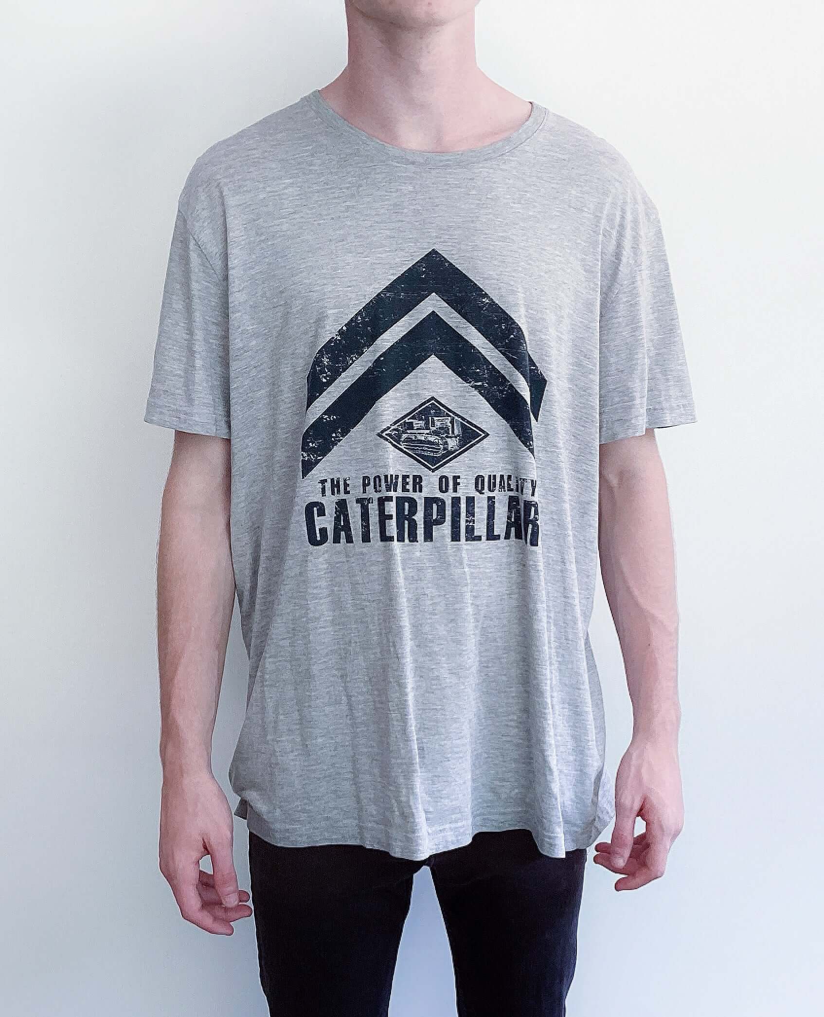 Front view of light grey, drop shoulder tshirt, black printing of caterpillar across the front.