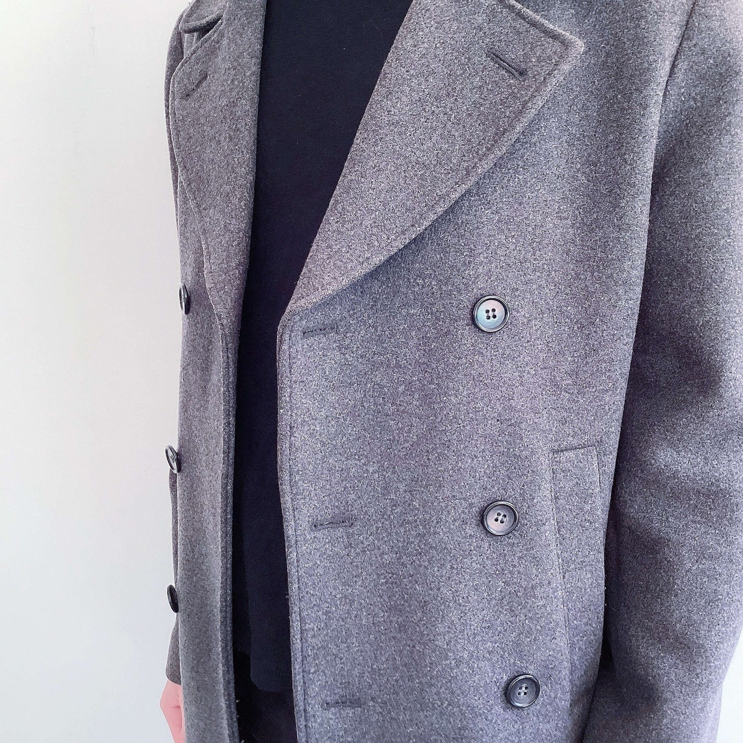 Grey wool formal coat, double-breasted, dark grey buttons, detail view.