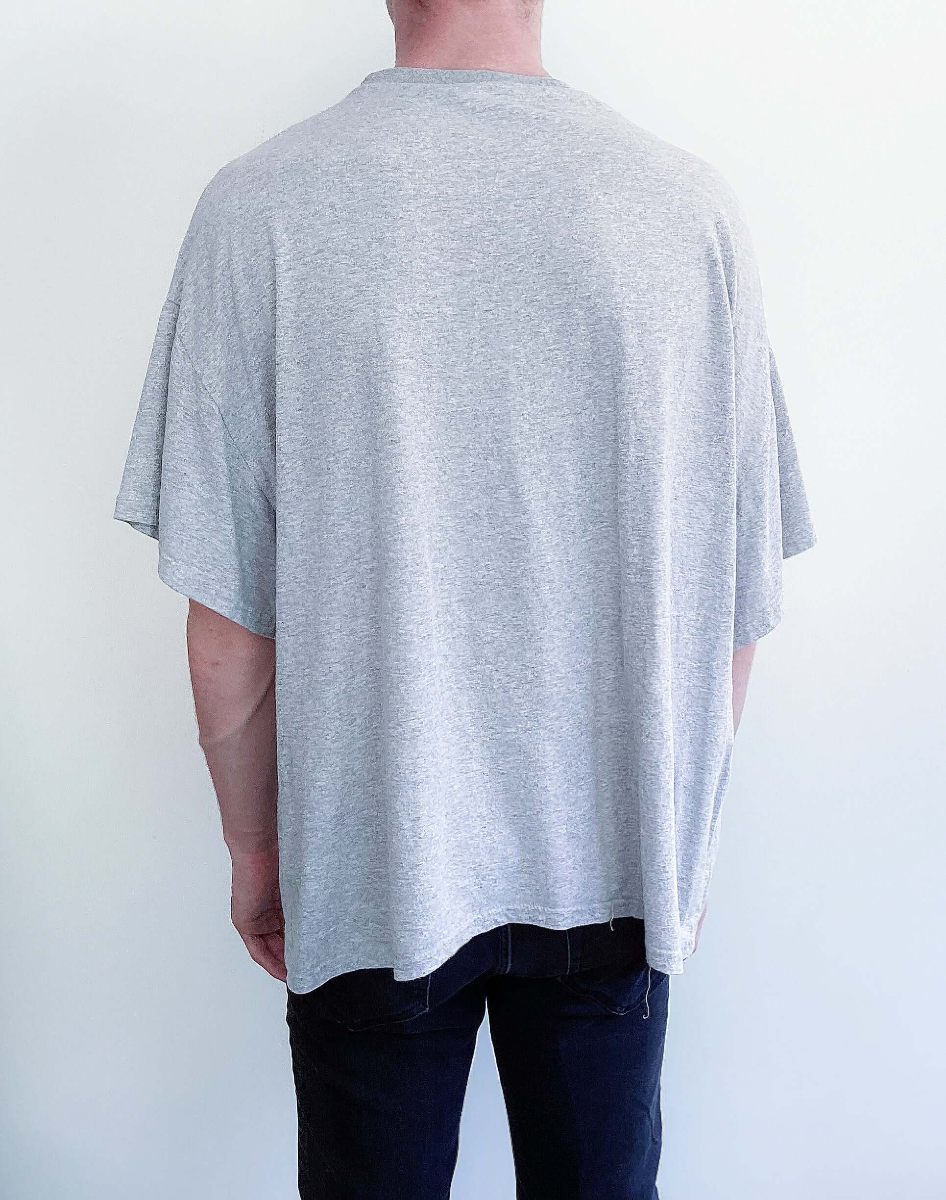 Back view of light grey, dropped shoulder tshirt, no print.