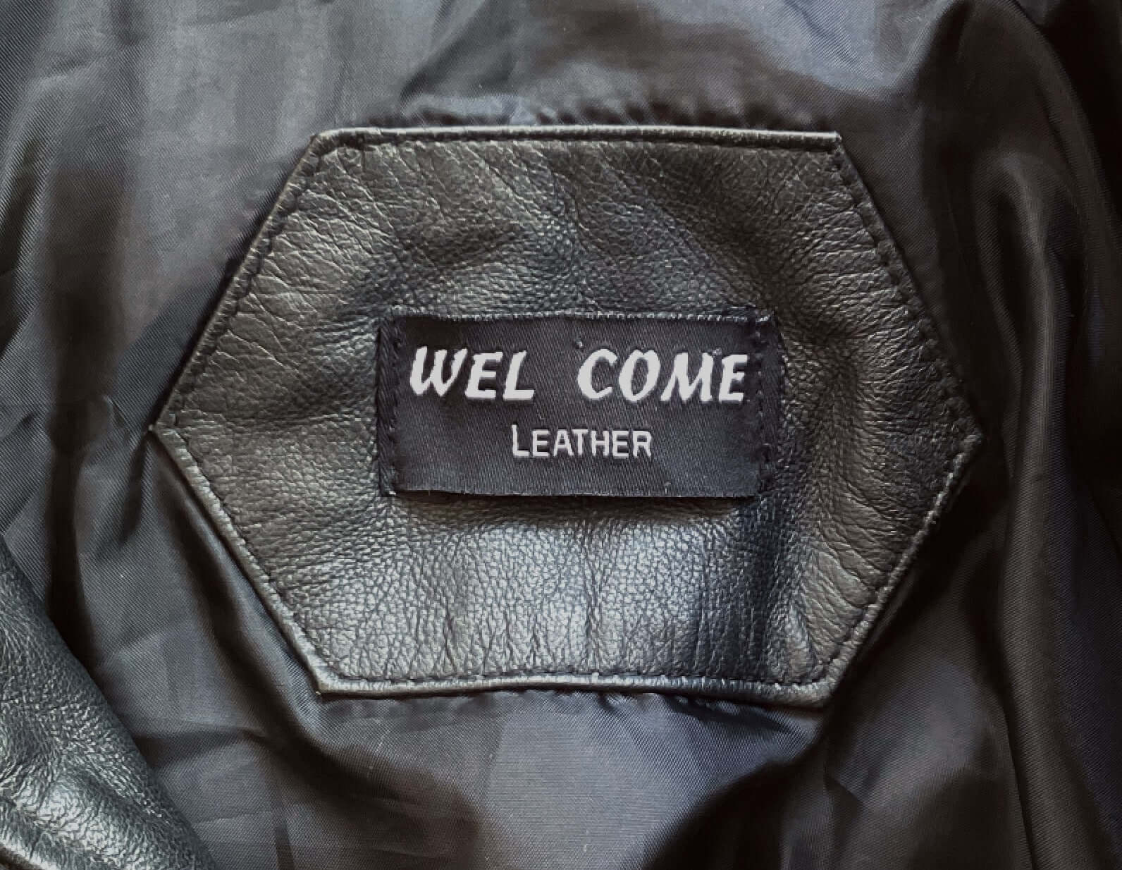 View of jacket label which says welcome.