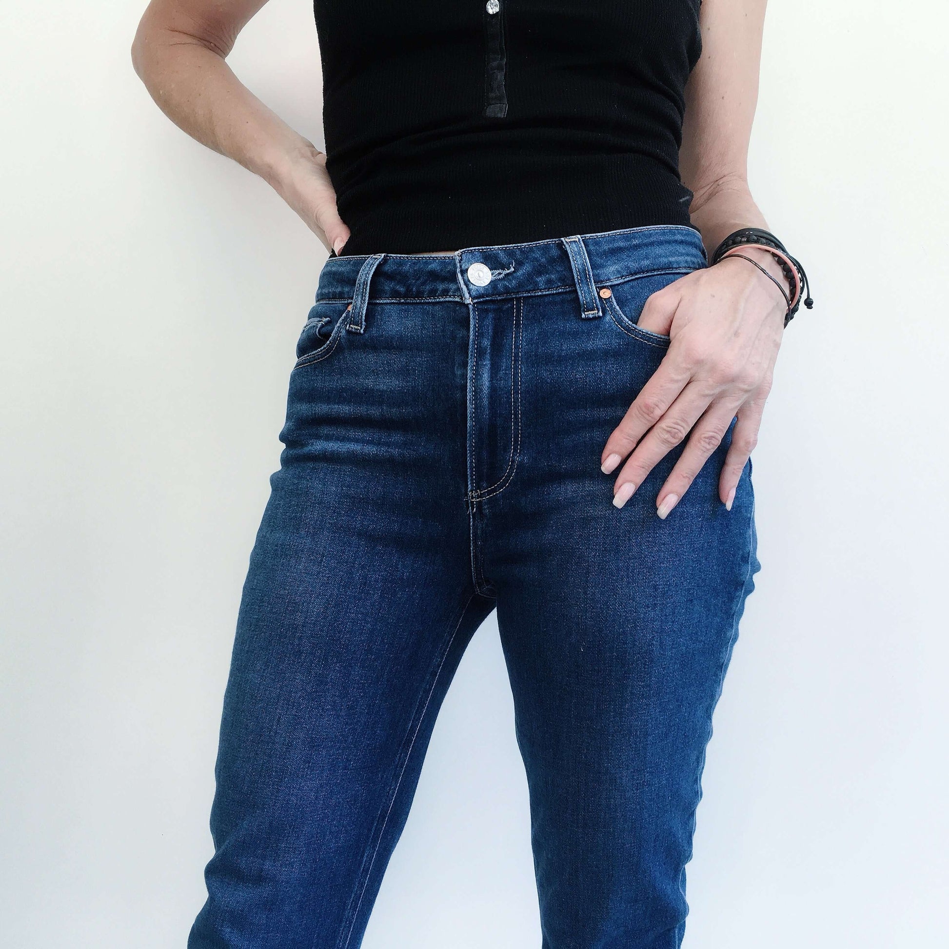 Front view uniform color navy blue jeans showing waist to knee.