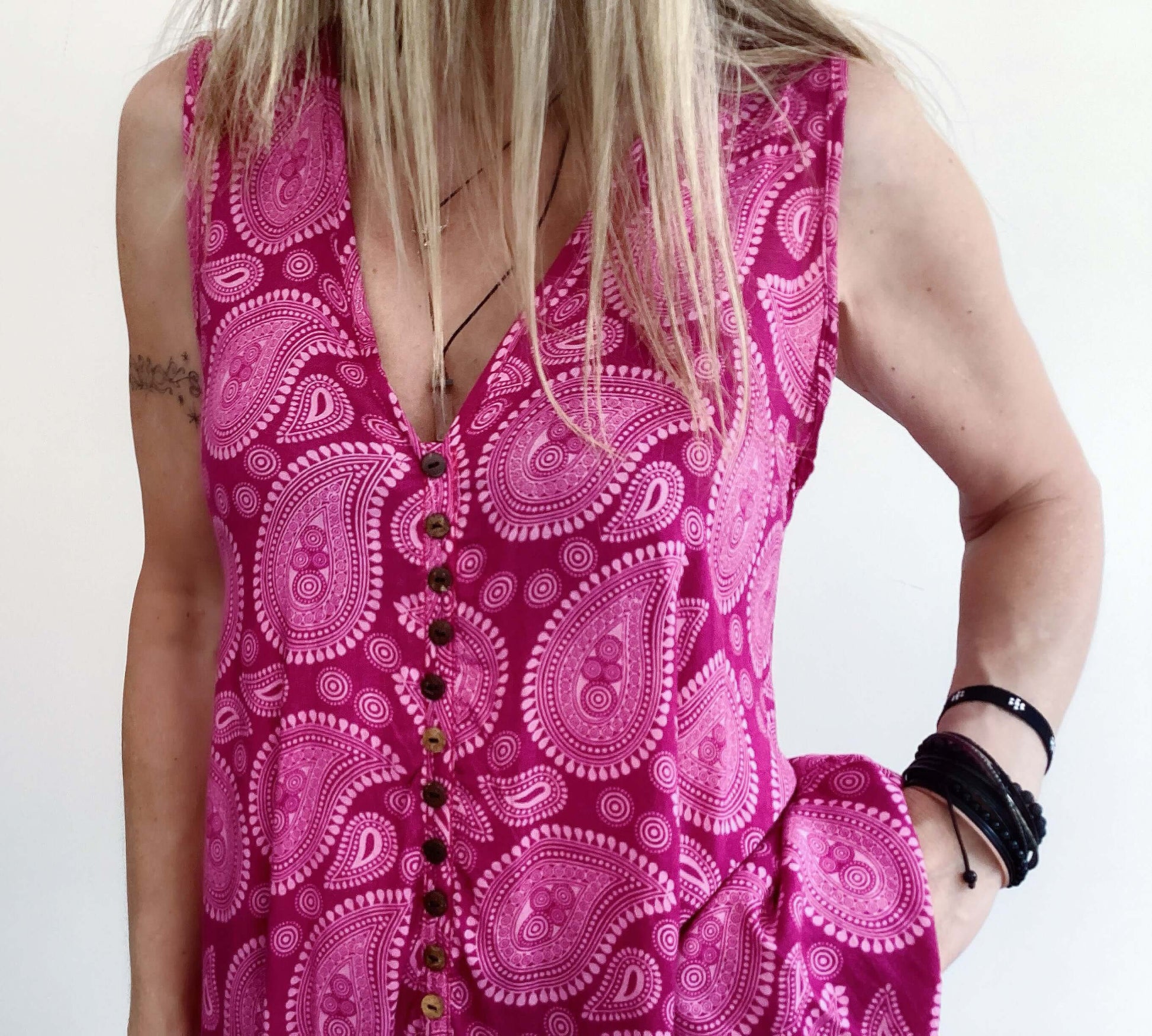 Front detail view of button up tunic top, sleeveless v neck.