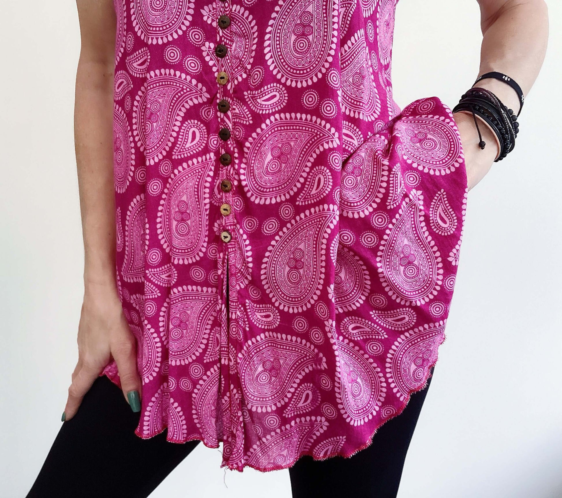 Detail front view of button up tunic top, cut wide around the hip.