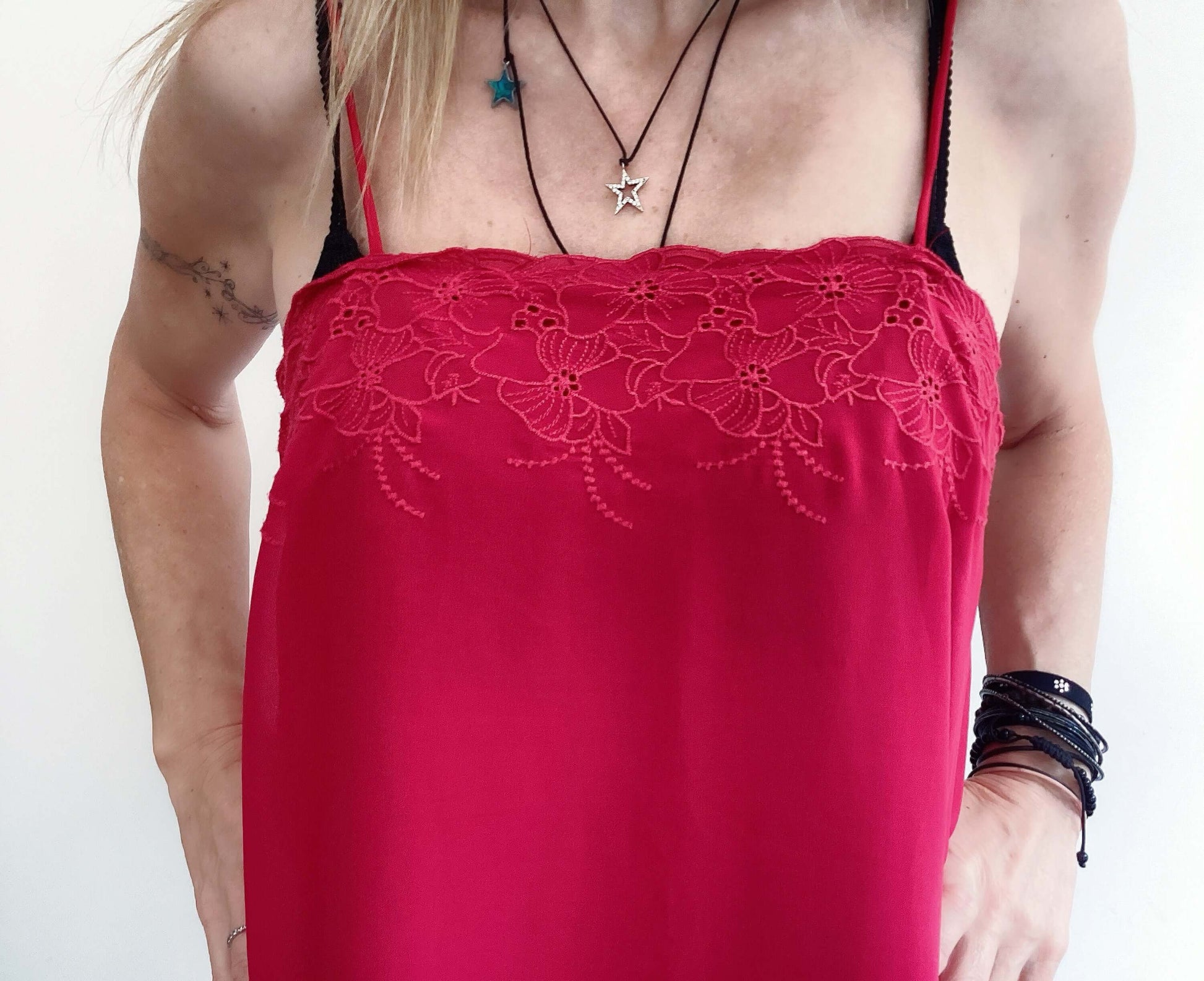 Detail view of top, shoe string straps, square neckline, red embroidery over bust area.