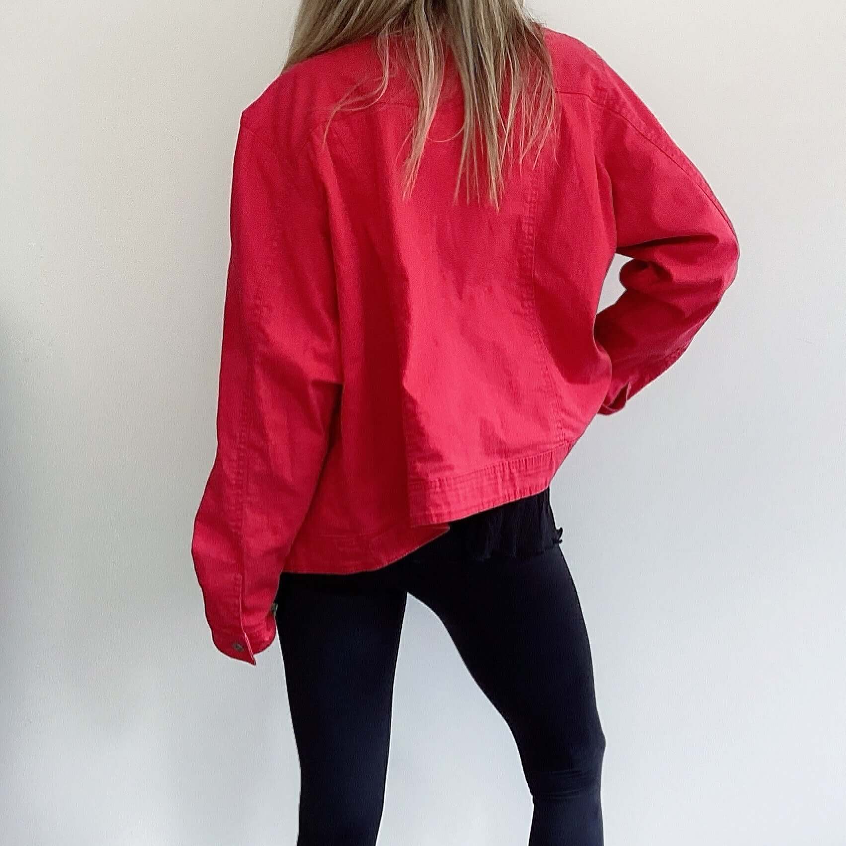 Back view of red denim jacket, hip length.