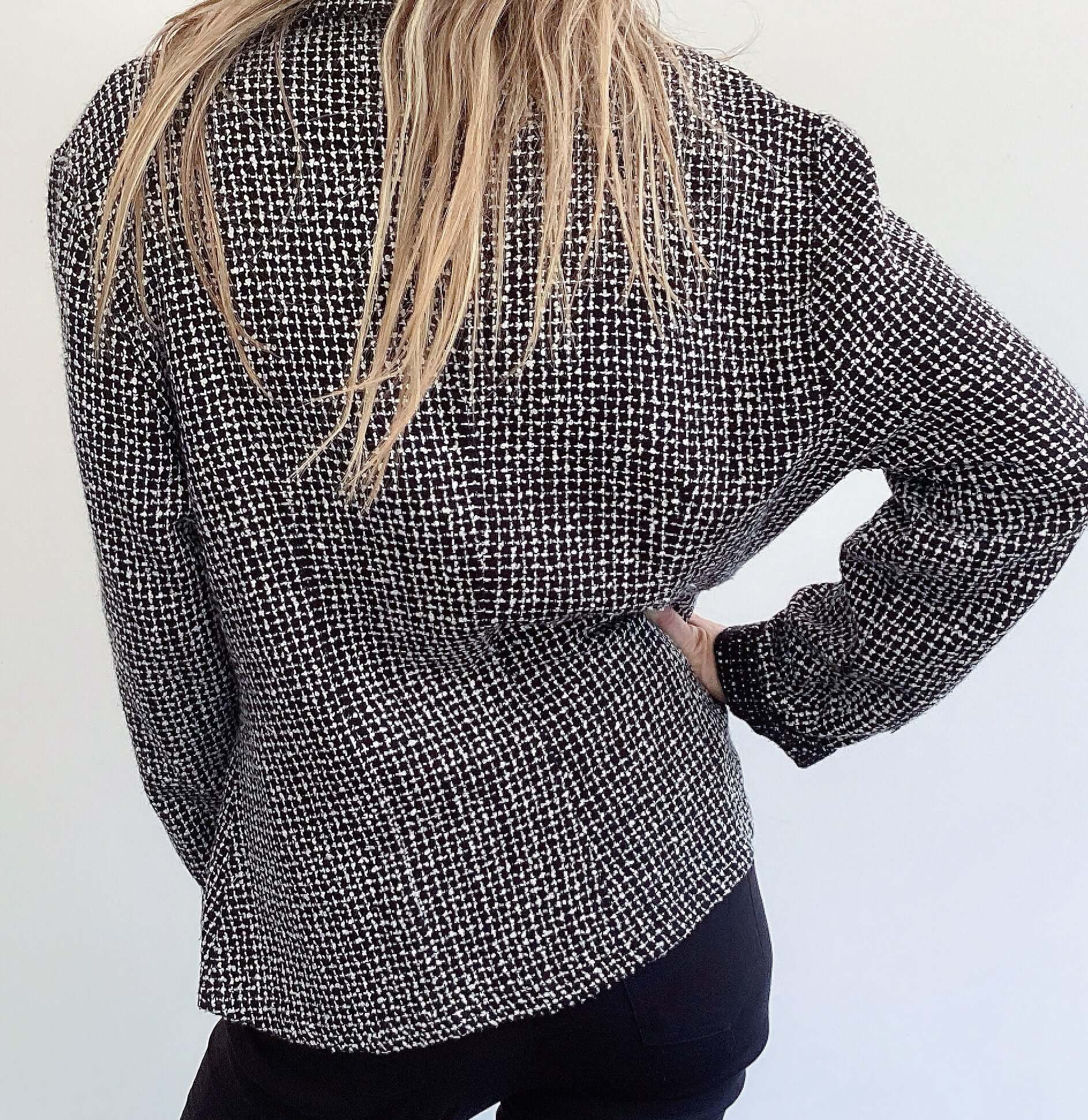 Back view of black and white soft tweed blazer.