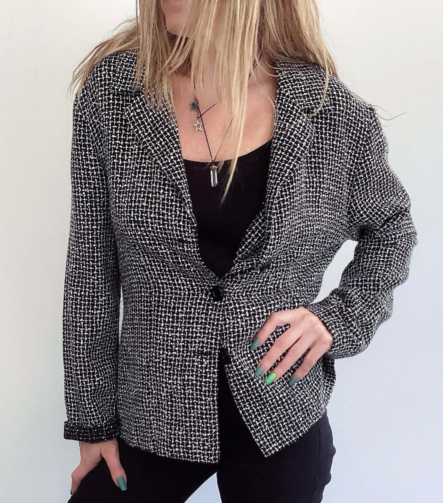 Front view of black and white soft tweed blazer with 3 black buttons.