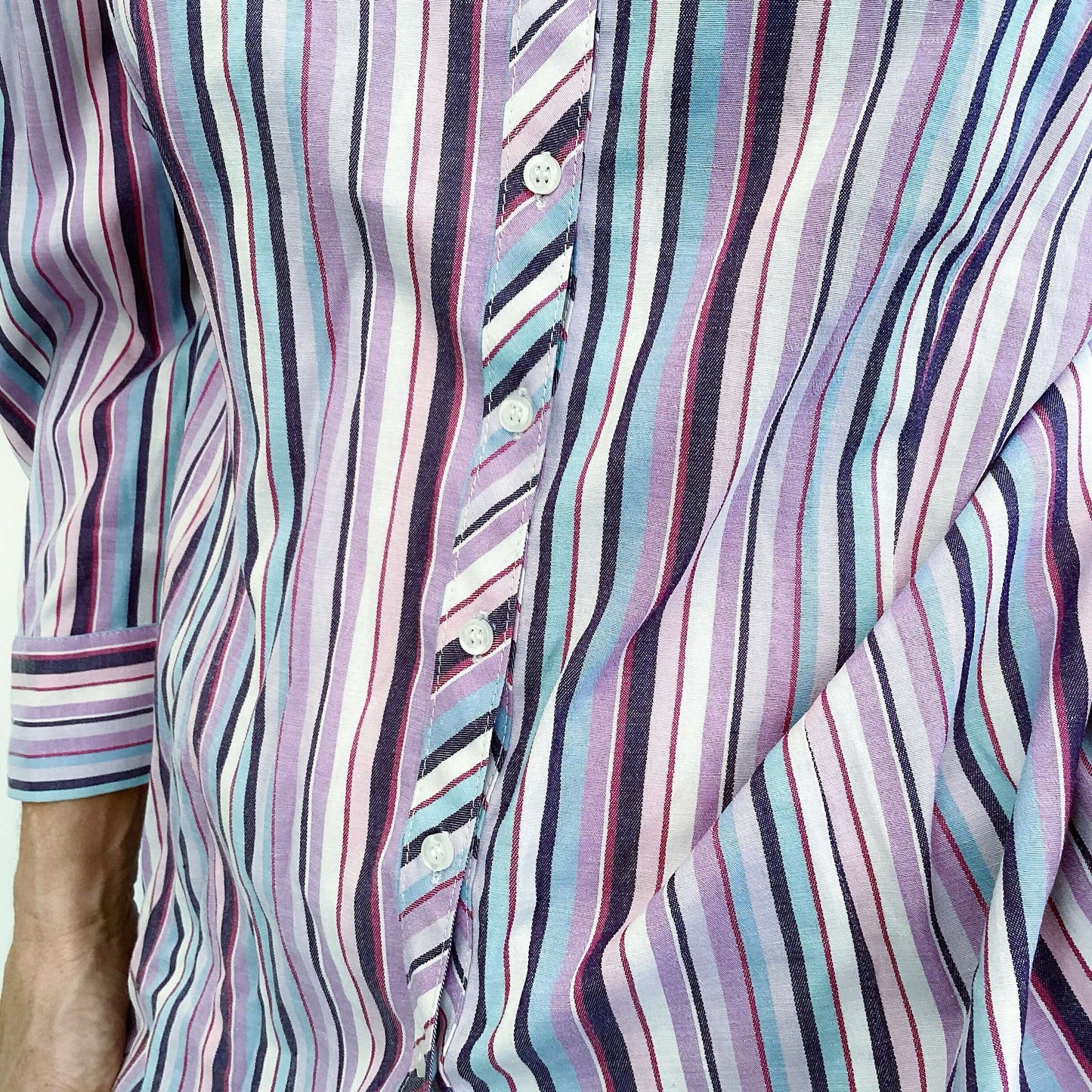 Striped ladies shirt in purple, turquoise and white, button down, front view detail.