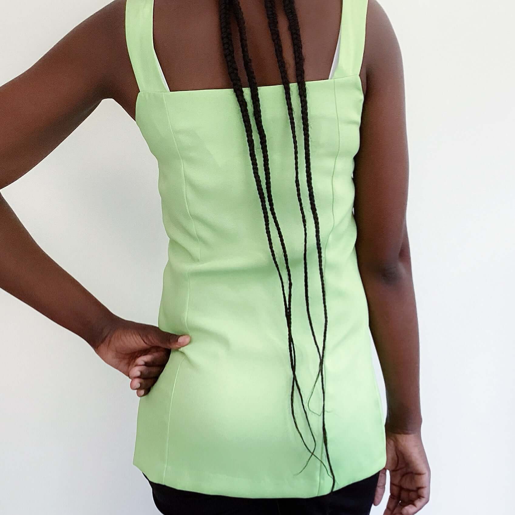 Back view of avo mint double breasted cami top, off white buttons, upper thigh length.