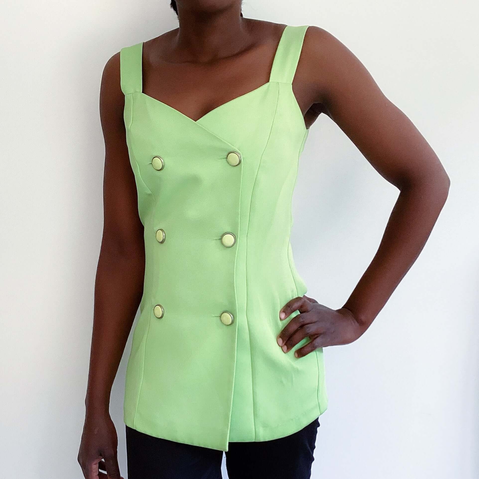 Front view of avo mint double breasted cami top, off white buttons, upper thigh length.