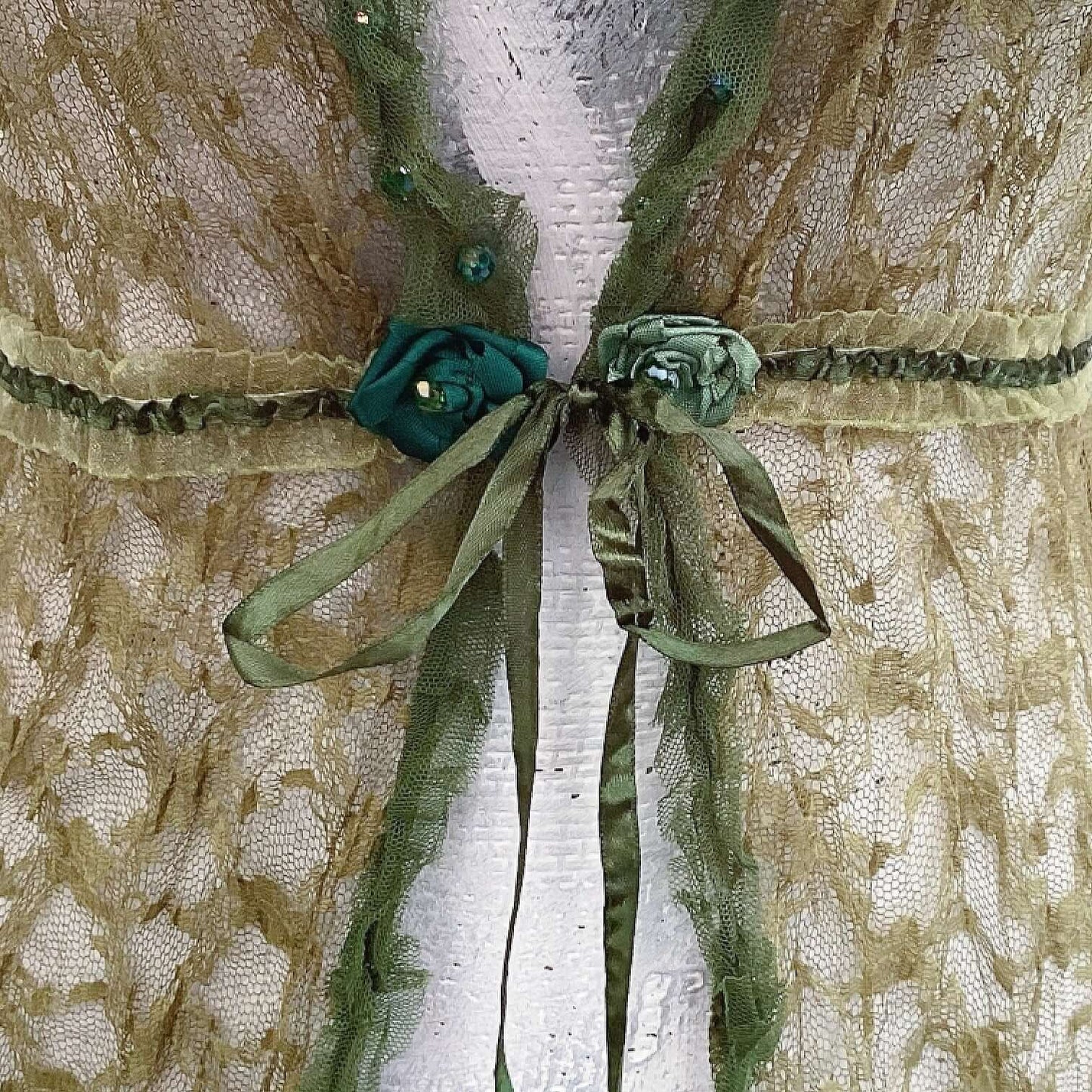 Close up view of jacket, with green ribbon tie in the center. 