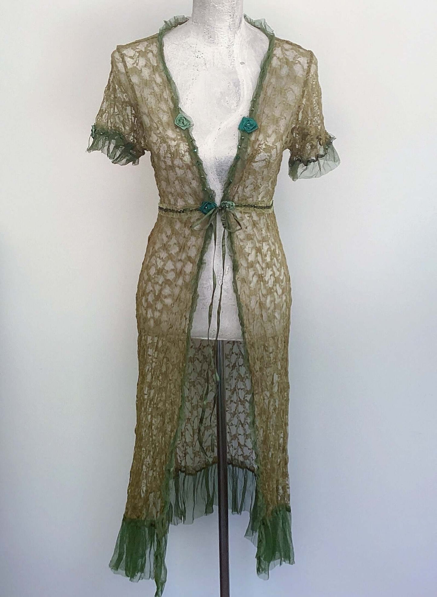 Front view of tie jacket, olive lace all over, with different olive tone small net frill on short sleeve and on hem.