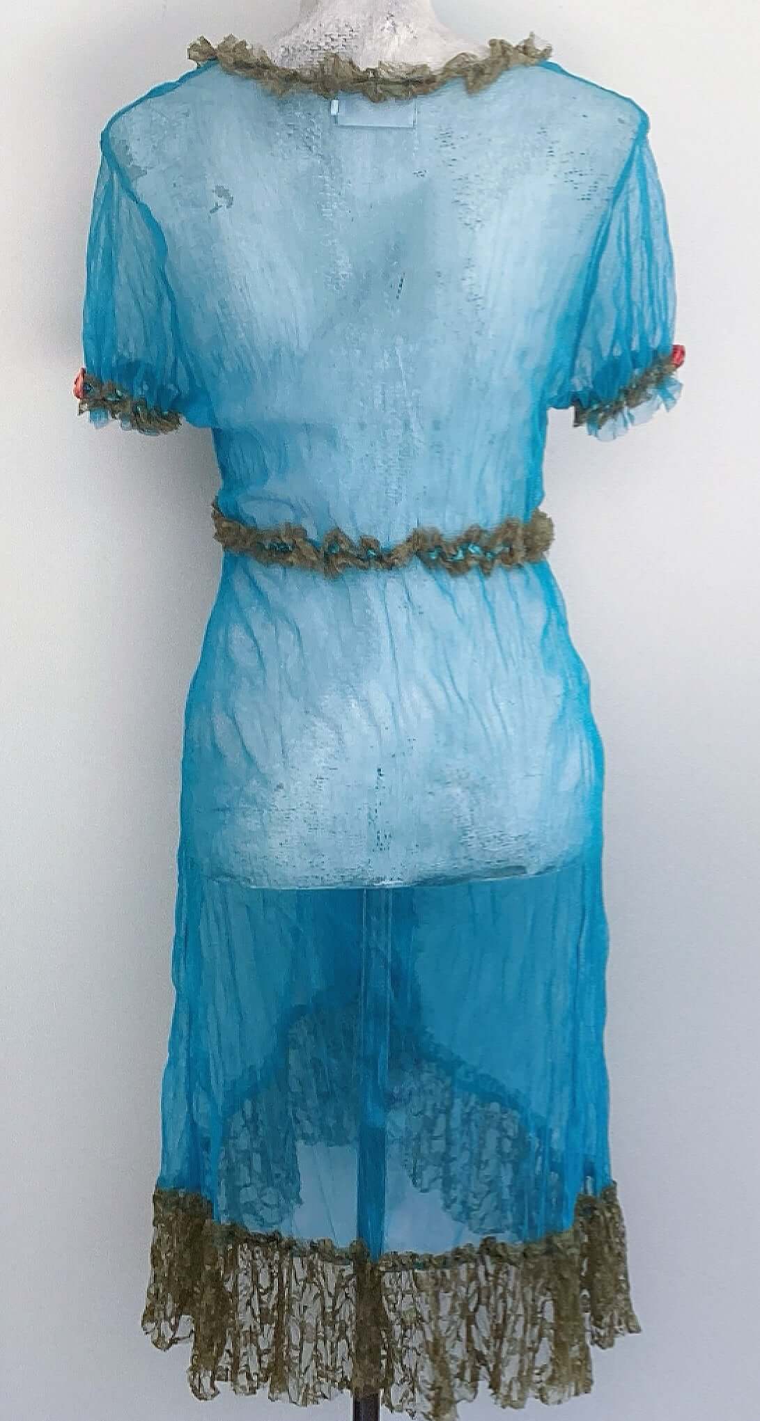 Back of turquoise net jacket, small olive lace ruched frill on all seams, with 12cm frill on hem, elasticated short sleeve.