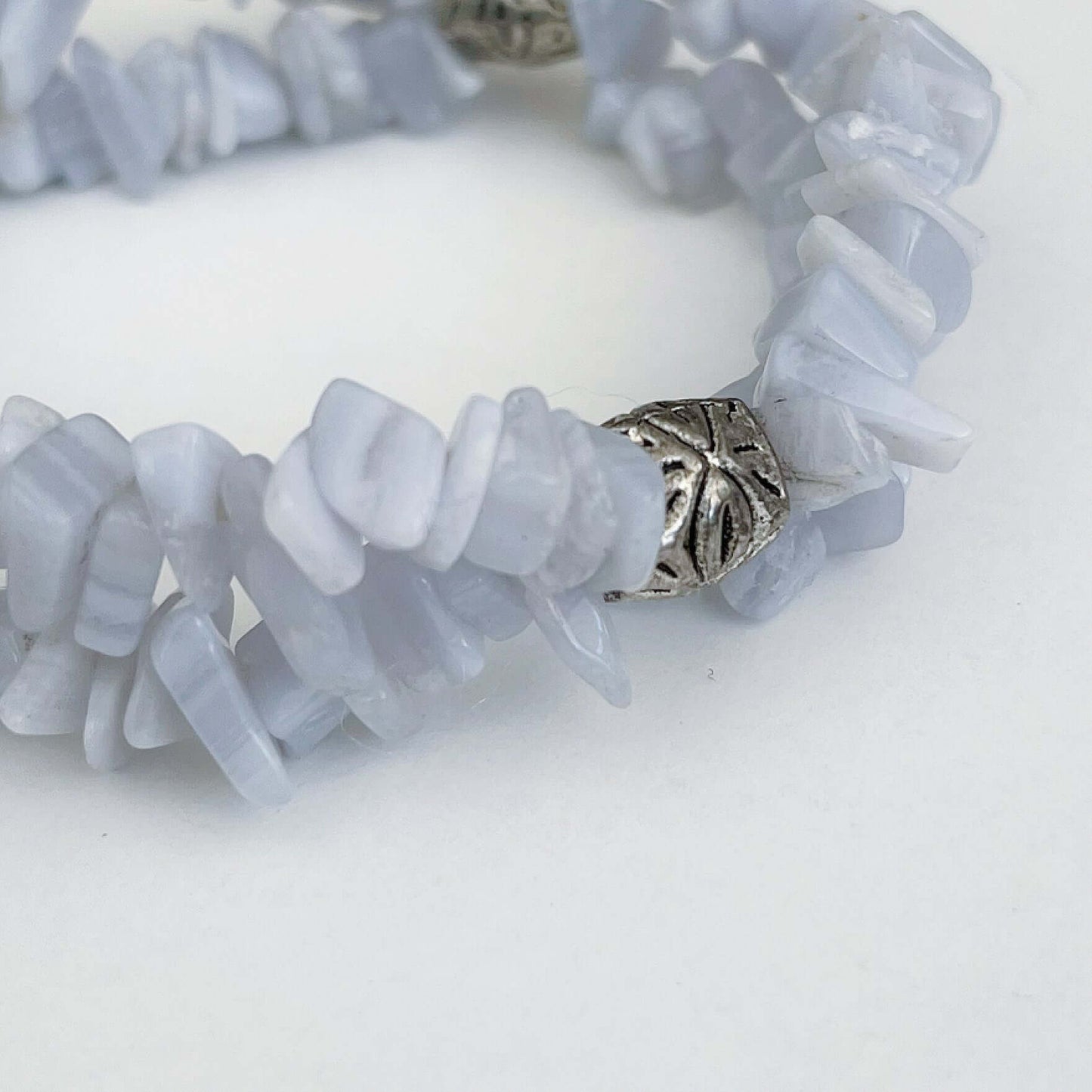 Detail view of double strand tumbled chip bracelet, with a silver finish bead positioned in 3 places.