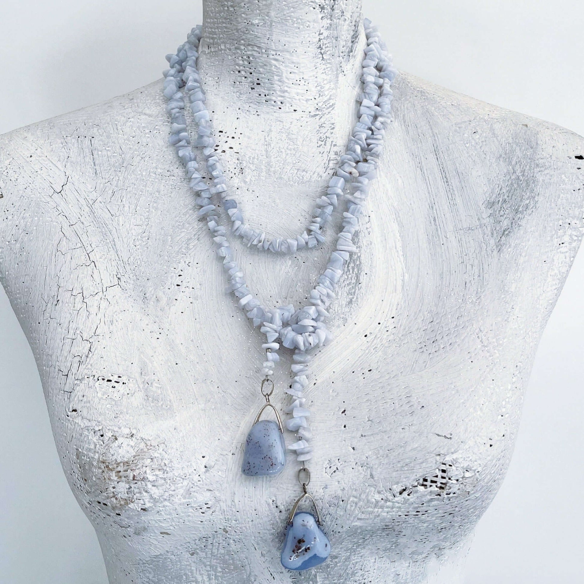 Front view of the Blue Lace Agate necklace loosely wrapped around the neck and casually tied in the front.