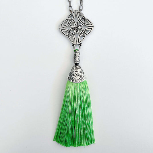 Detail view of the silver finish Celtic pendant, with green tassel on the end.