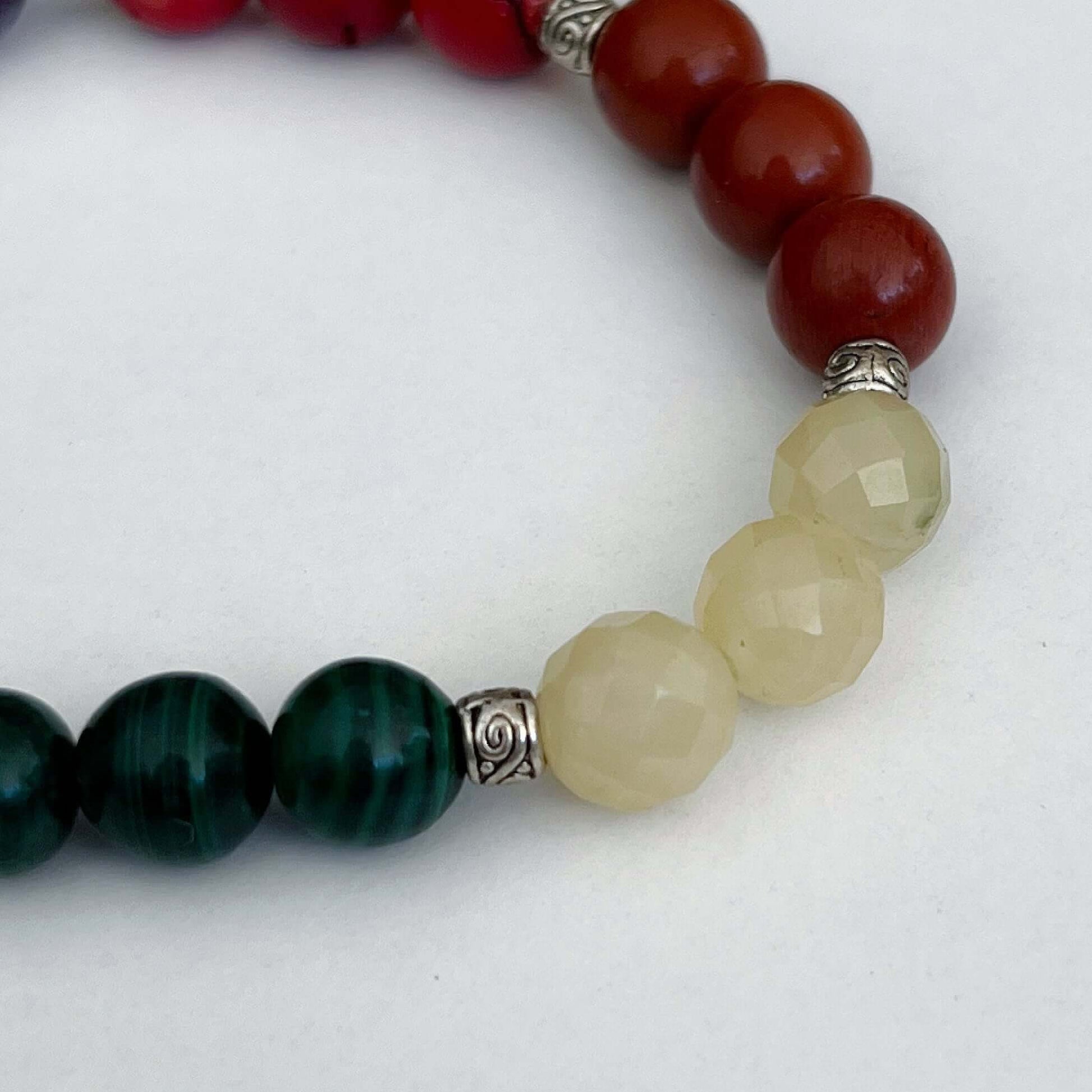 Detail view of bracelet showing Malachite, Rose Quartz, Coral.