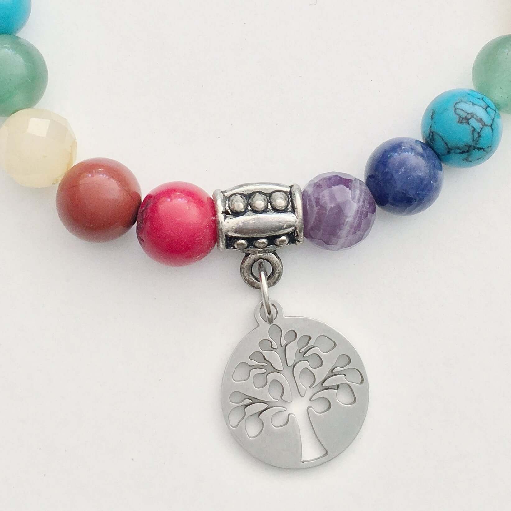 Detail view of beaded bracelet with matching 3 bead dangle and Tree Of Life attached to silver bead.