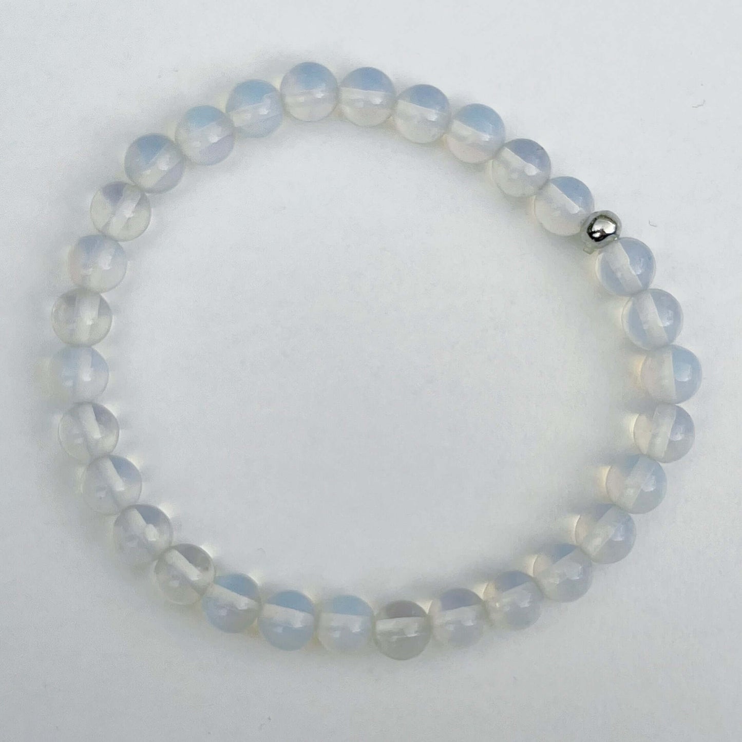 Top view of the elasticated bracelet, in shades of white/clear/opalescent