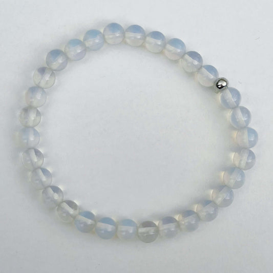 Top view of the elasticated bracelet, in shades of white/clear/opalescent