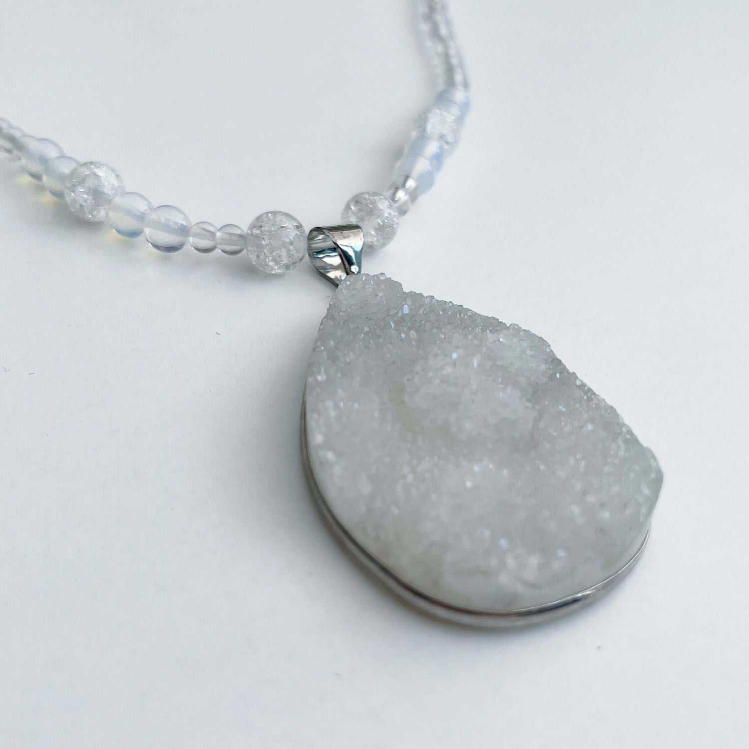 Detail view of the geode pendant. the depth is almost 1cm, delicate crystal on entire surface.