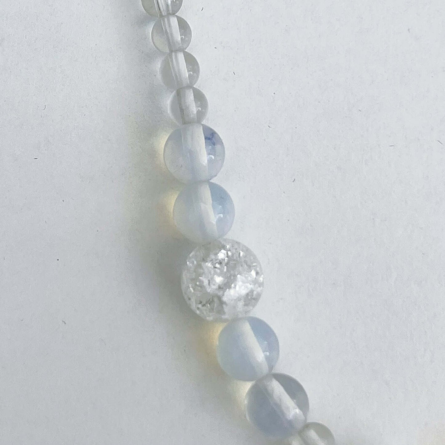 Detail view of the Opal and Clear Quartz Crystal smoothe round beads.