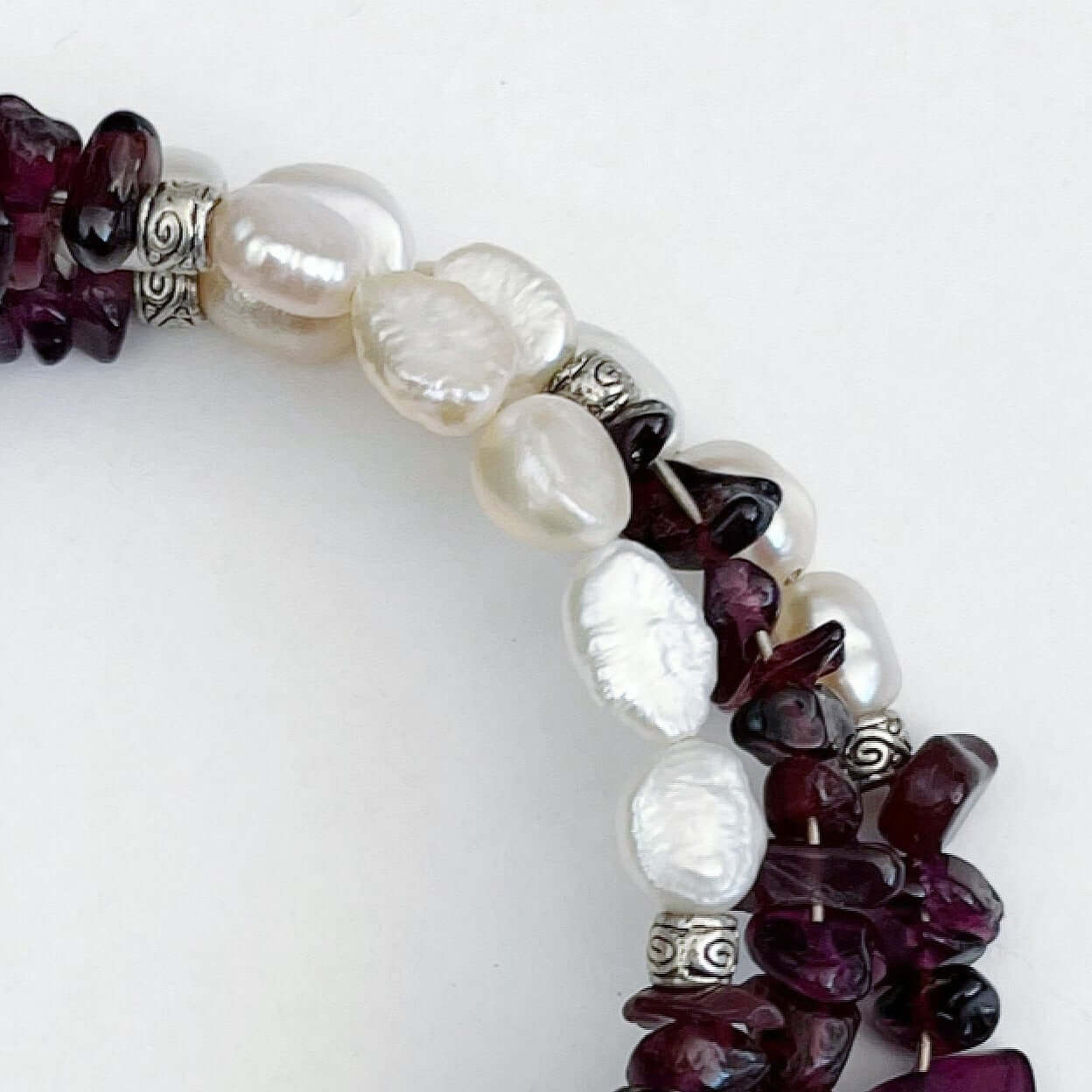 Detail view of bracelet, showing the fresh water pearls. 