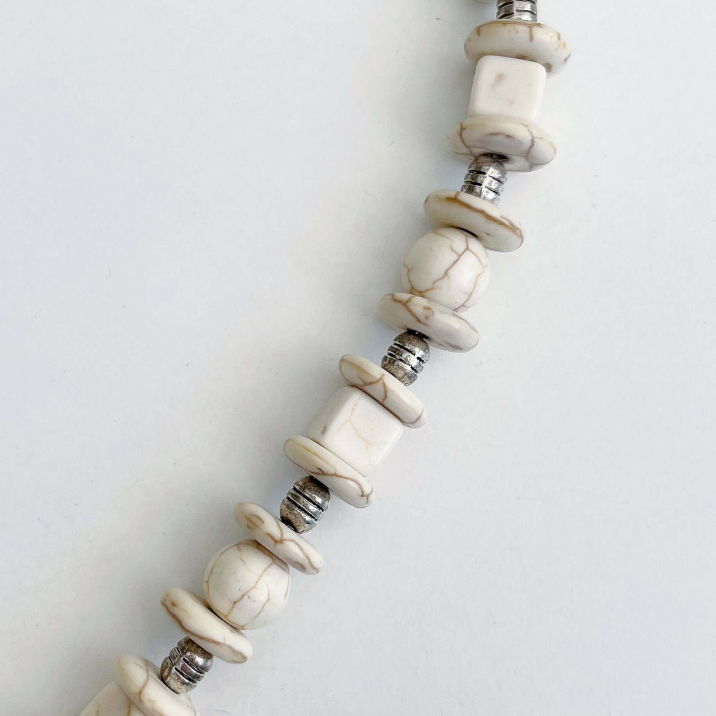 Detail view of necklace showing the Howlite beads.