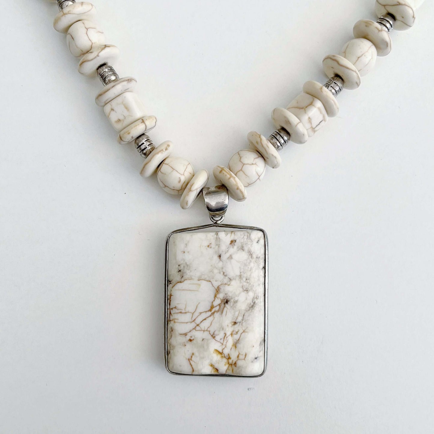 Detail view of necklace showing the rectangular Howlite pendant.