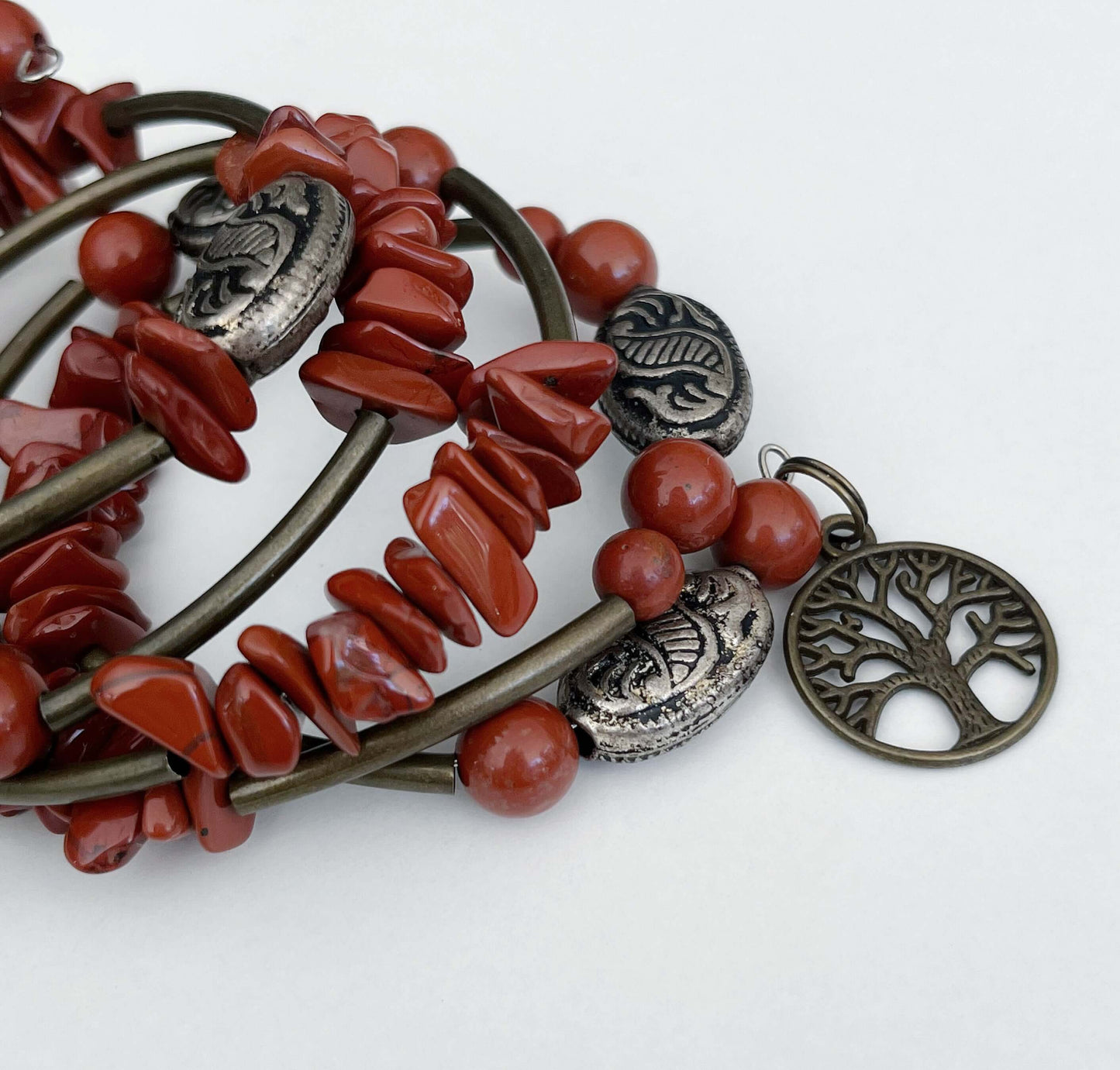 Top of bracelet, both tumbled and round Red Jasper beads, mixed with bronze colored long tubular and antique style beads.