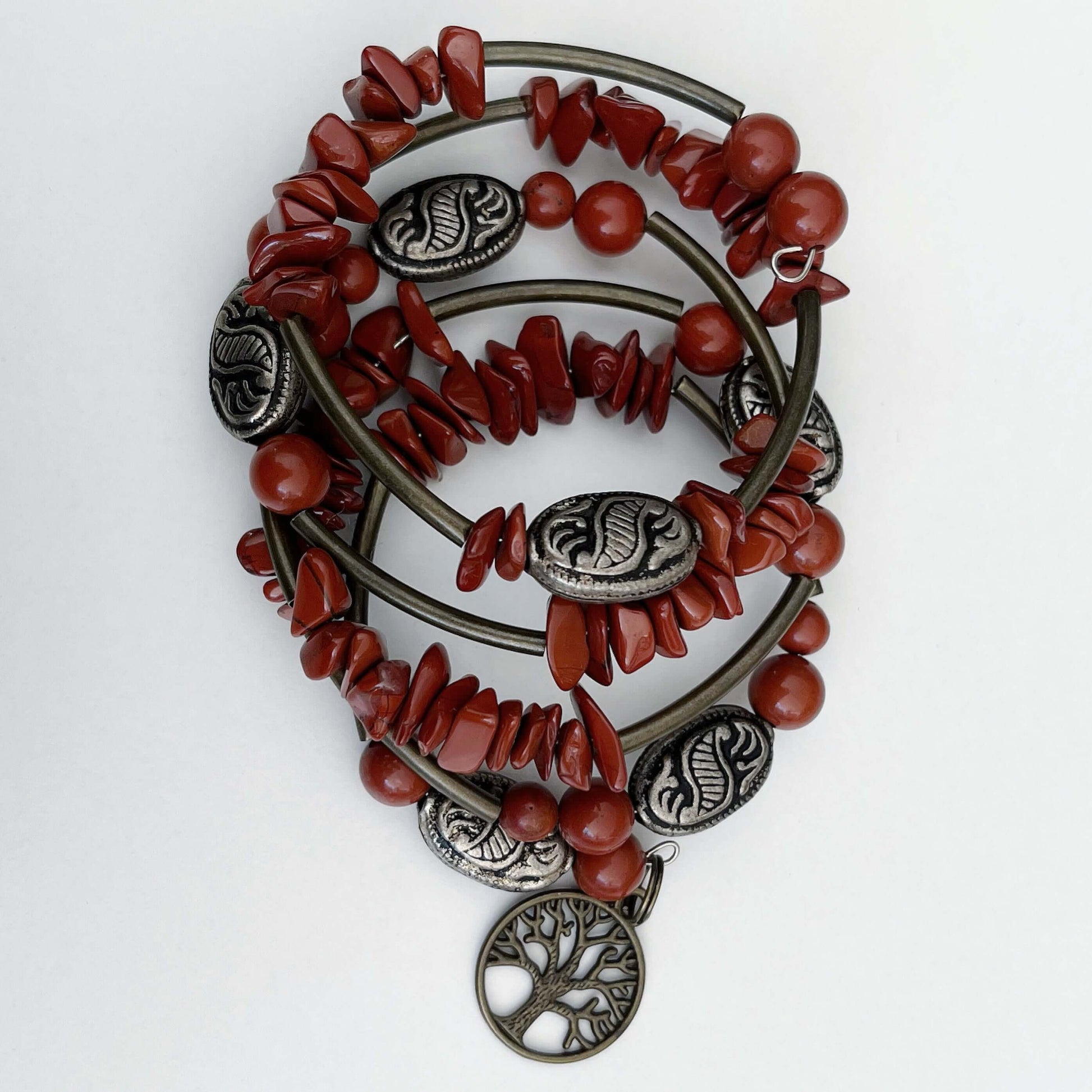 Top of bracelet, both tumbled and round Red Jasper beads, mixed with bronze colored long tubular and antique style beads.