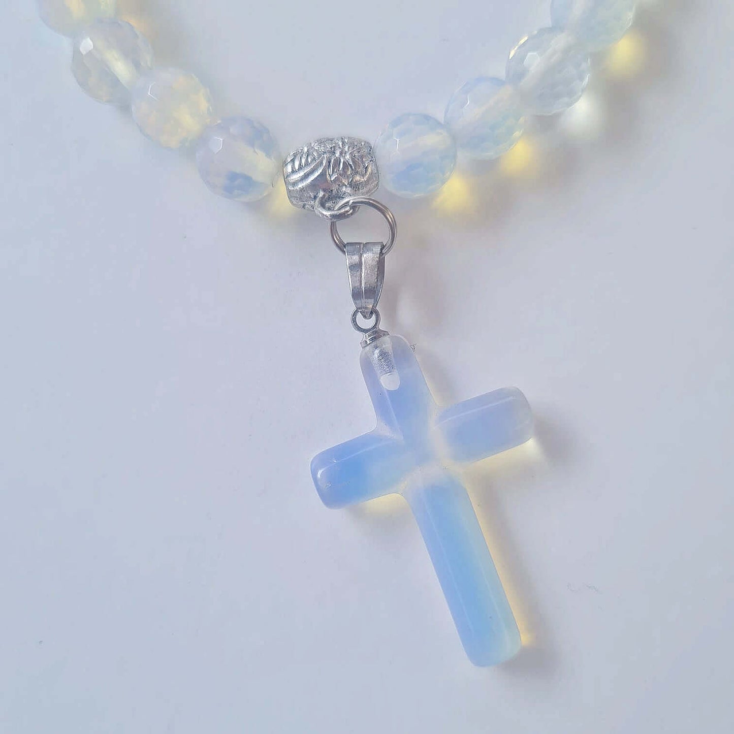 Detail view of faceted bead bracelet with matching Opalite cross.