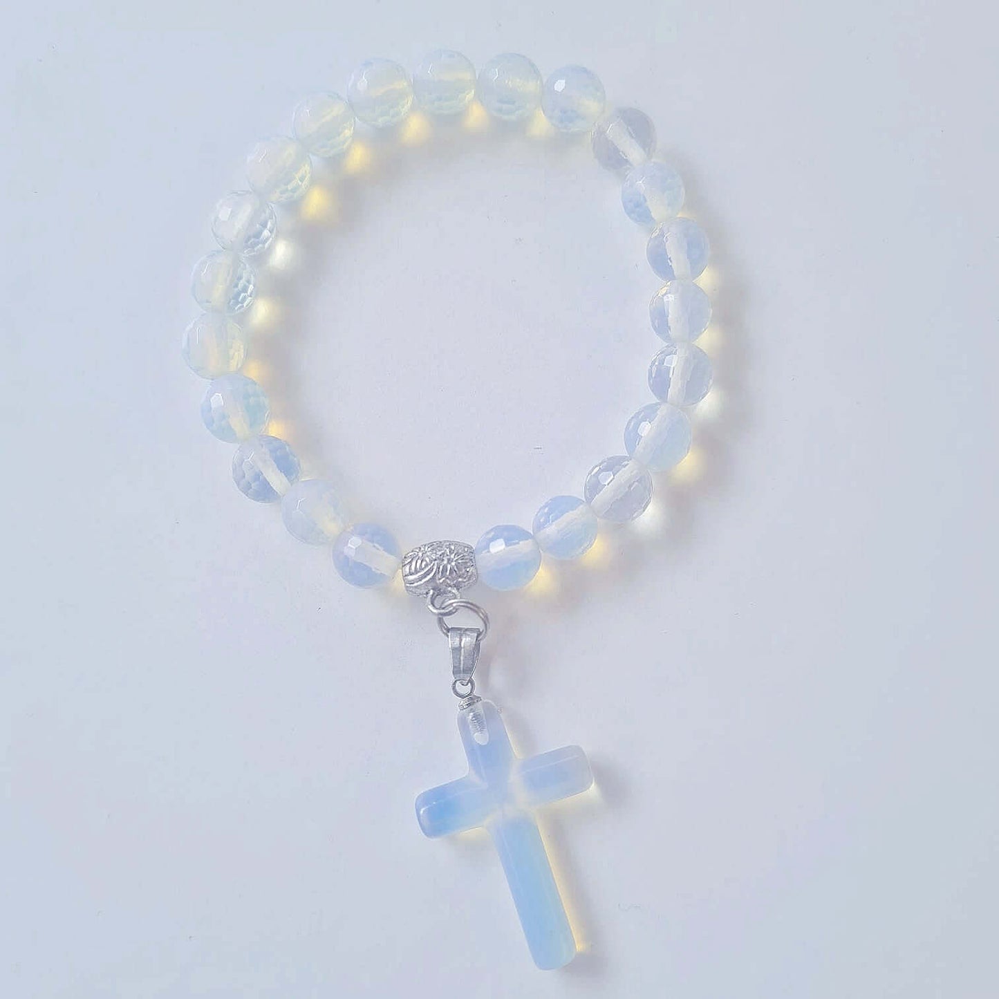 Top view of faceted bead bracelet with matching Opalite cross.