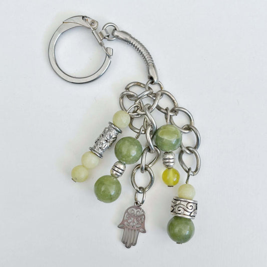 Top view of keyring showing 5 dangling chains each with beads, and one with the Hamsa charm.