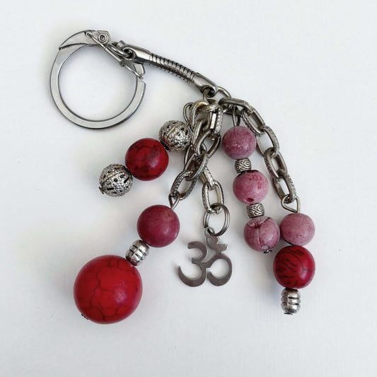 Top view of keyring showing 5 dangling chains each with beads, and one with the Om sign charm.
