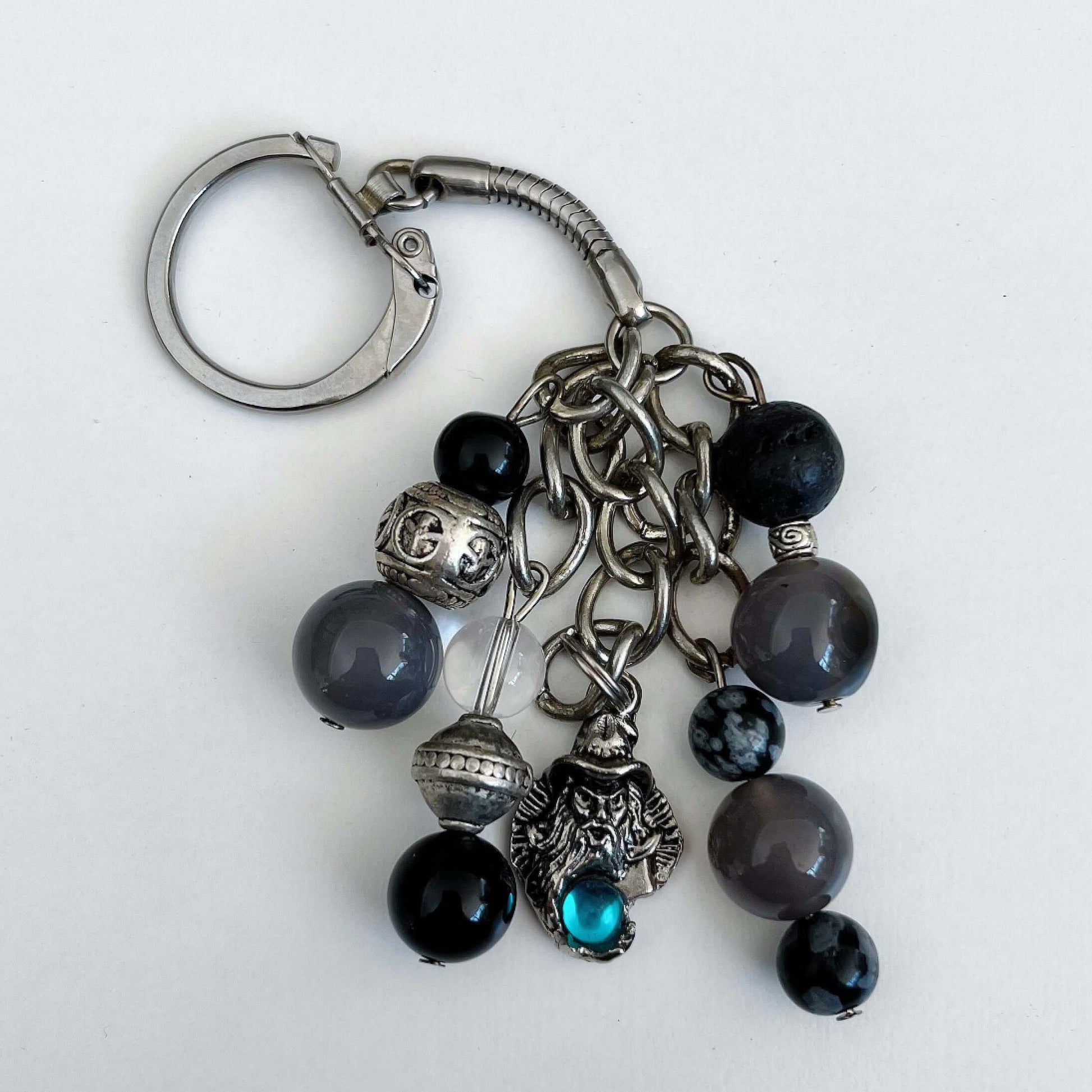 Top view of keyring showing 5 dangling chains with beads, one with the wizard charm containing a turquoise diamanté.
