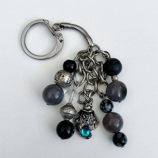 Top view of keyring showing 5 dangling chains with beads, one with the wizard charm containing a turquoise diamanté.