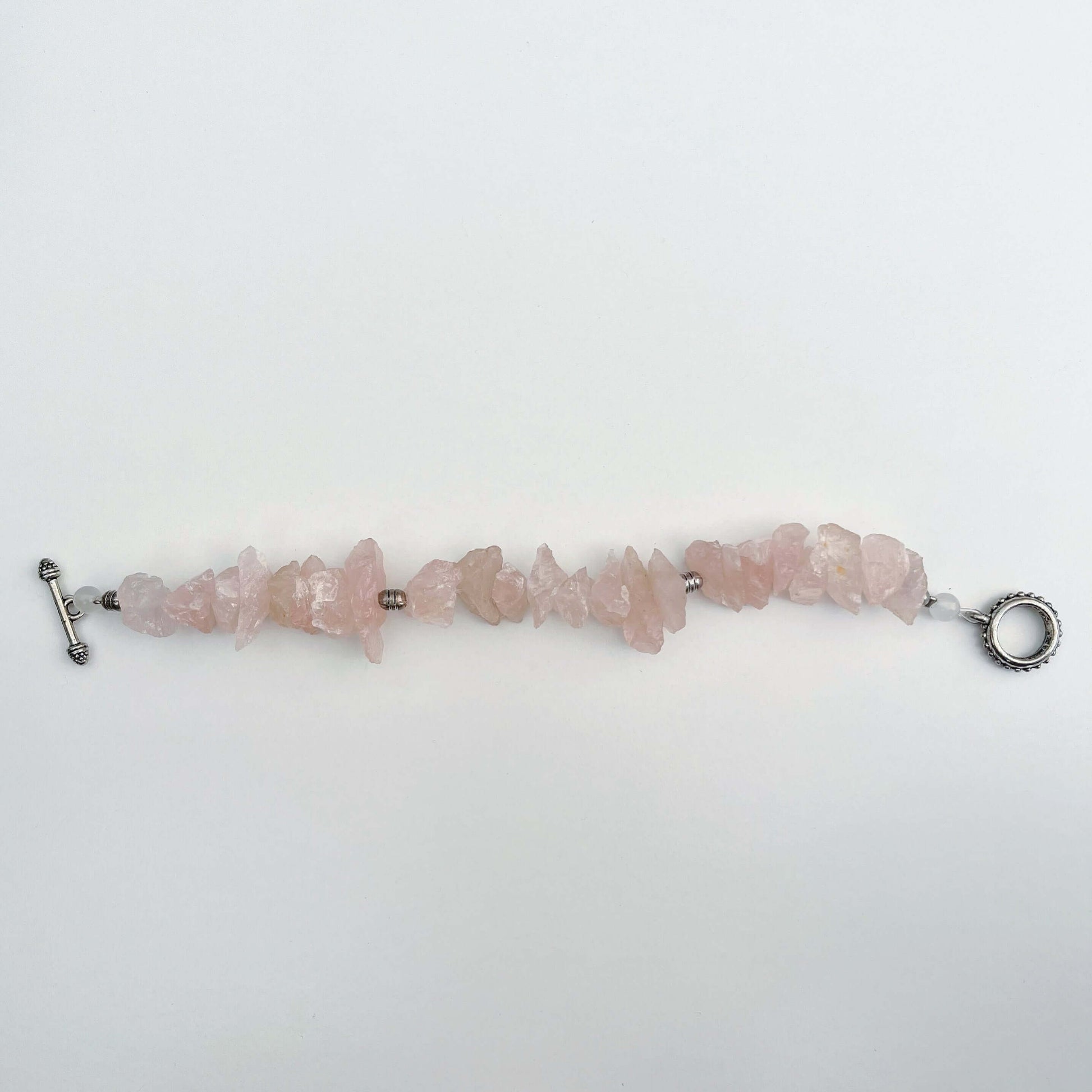 Top view of the rough Rose Quartz bracelet lying unclasped.